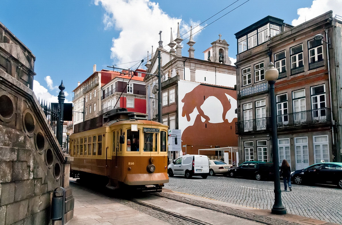 Old yellow Oporto tramway on Rua Infante Dom Henrique in a sunny day