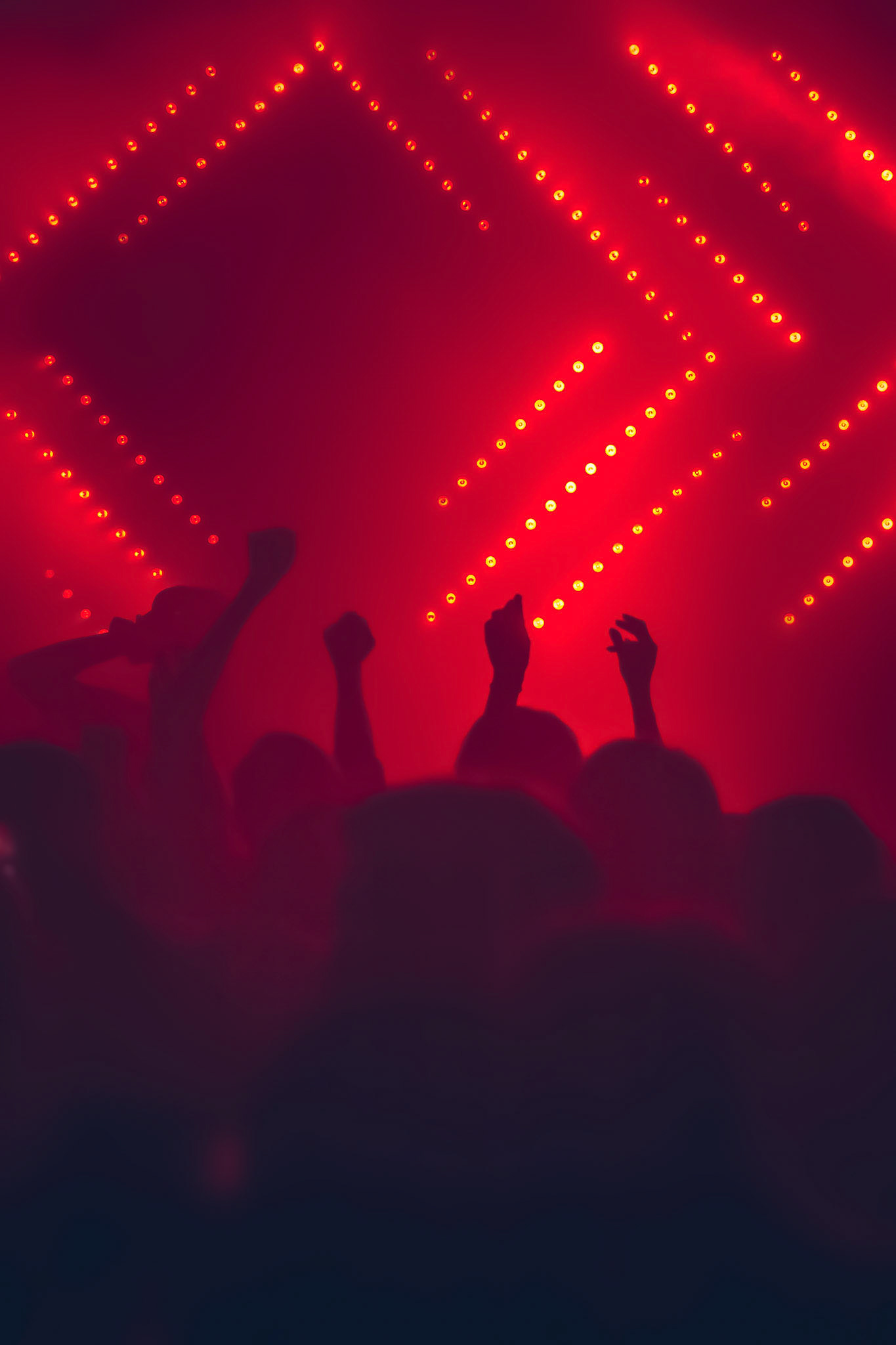 Dancing people's silhouettes at night techno party
