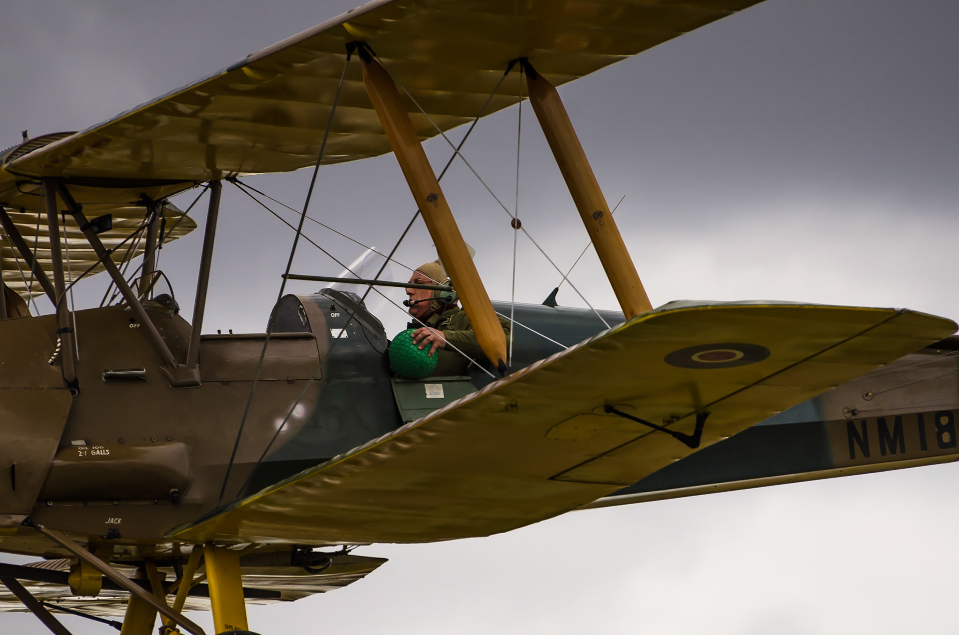 A Tiger Moth Pilot makes an approach to bowl during the air cricket display at Little Gransden