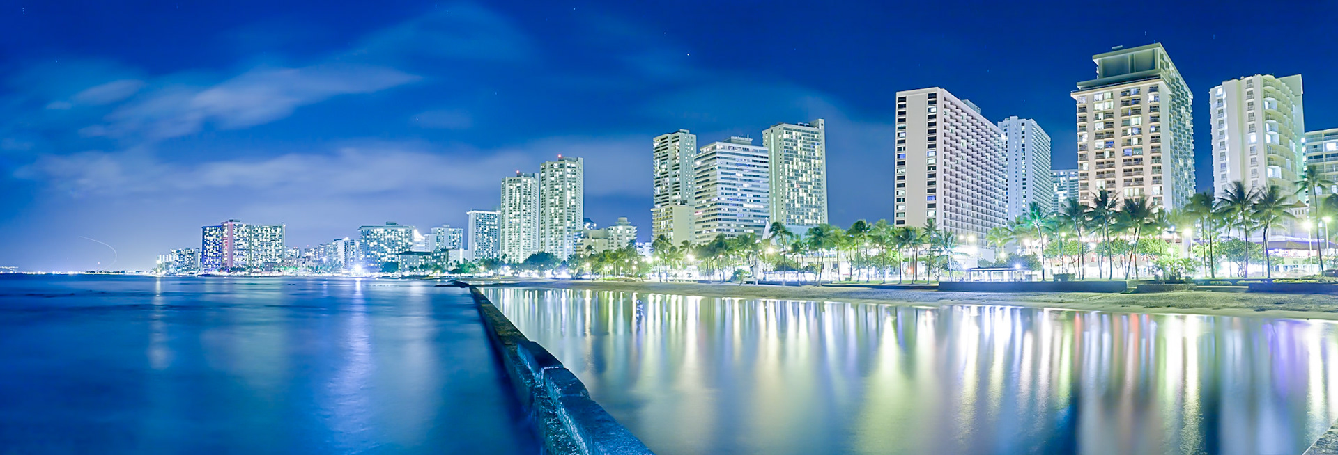 HDR Night panoramic of Waikiki Beach taken from the eastern end off the pier.
