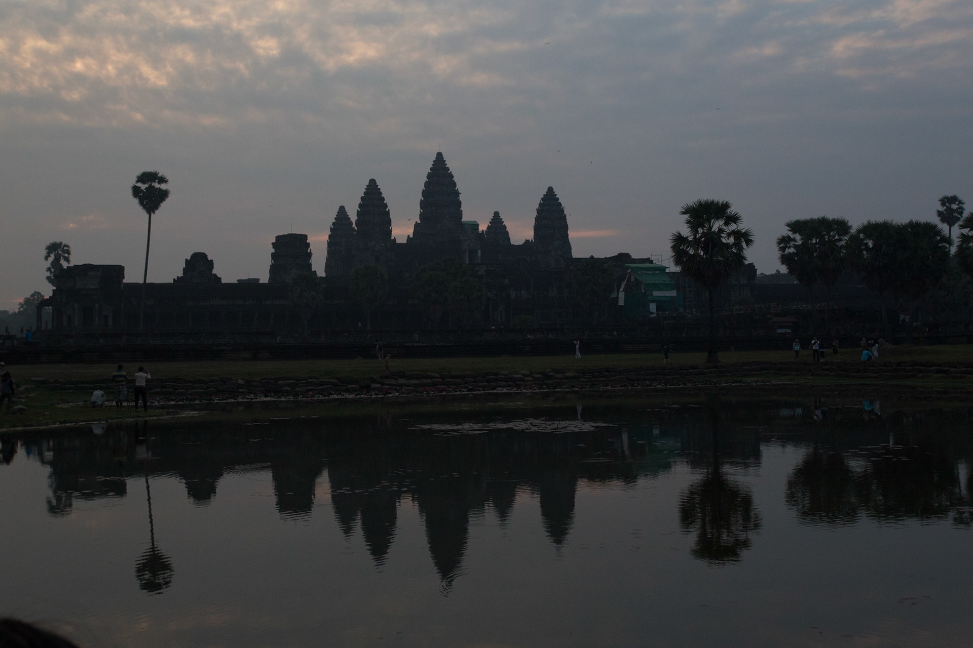 Angkor Wat is a temple complex at Angkor, Cambodia, built by King Suryavarman II in the early 12th century as his state temple and capital city. As the best-preserved temple at the site, it is the only one to have remained a significant religious centre since its foundation – first Hindu, dedicated to the god Vishnu, then Buddhist. The temple is at the top of the high classical style of Khmer architecture. It has become a symbol of Cambodia, appearing on its national flag, and it is the country's prime attraction for visitors. The modern name, Angkor Wat, means "City Temple".