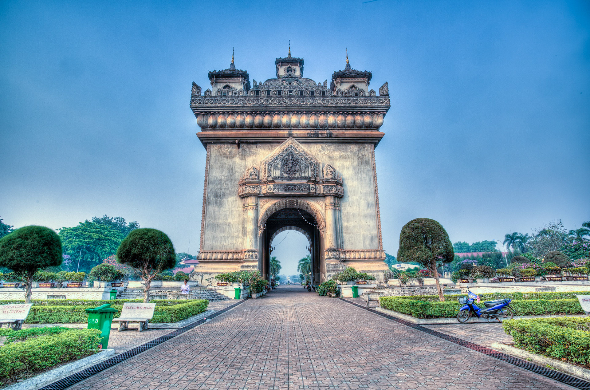 Patuxai (Lao: ປະຕູໄຊ, literally meaning Victory Gate or Gate of Triumph, formerly the Anousavary or Anosavari Monumentm known by the French as Monument Aux Morts) is a war monument in the centre of Vientiane, Laos, which was built between 1957 and 1968. Patuxai is dedicated to those who fought in the struggle for independence from France. In romanising the name from the Laotian language, it is variously transliterated as Patuxai, Patuxay, Patousai and Patusai. It is also given the name of Patuxai Arch or the Asian version of Arc de Triomphe of Vientiane as it has general resemblance to the Arc de Triomphe in Paris; however, it is typically Laotian in design, decorated with many Buddhist mythological figurines such as of kinnari (half-female, half-bird figures).