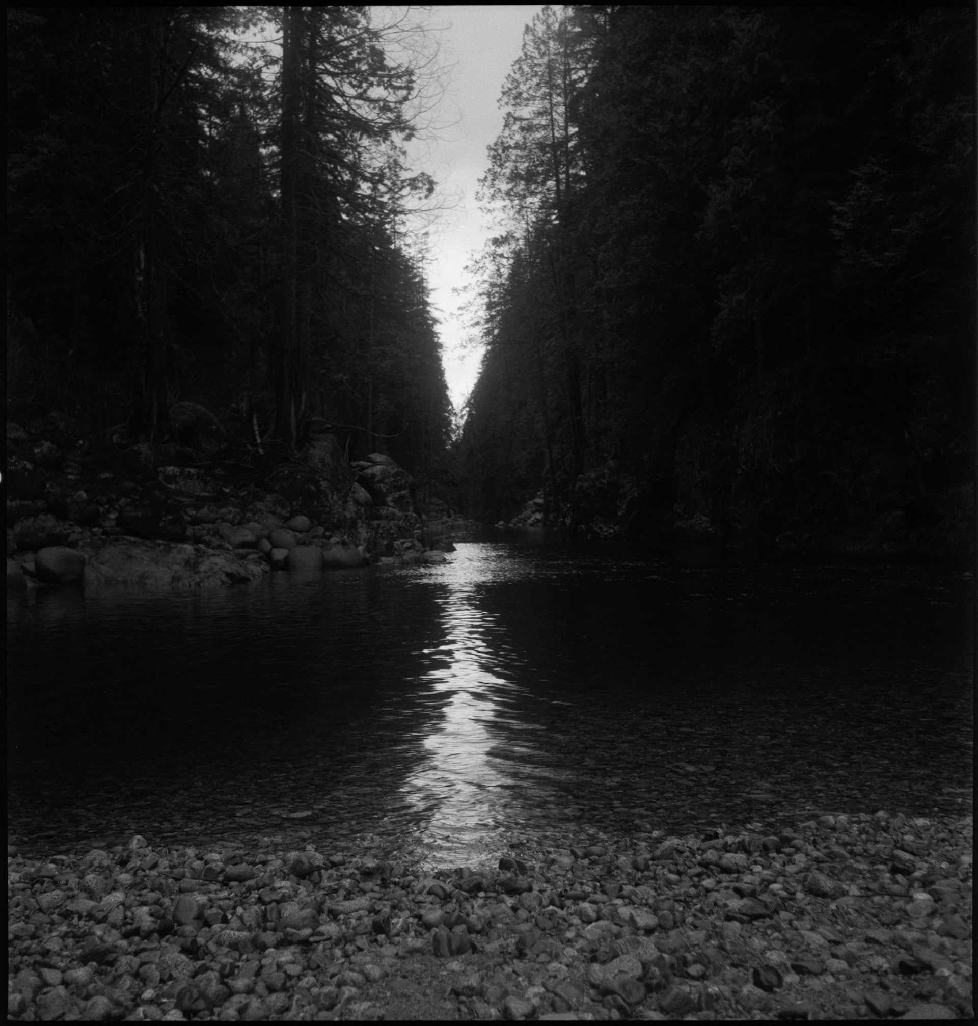 A beam of light emanates down a stream.