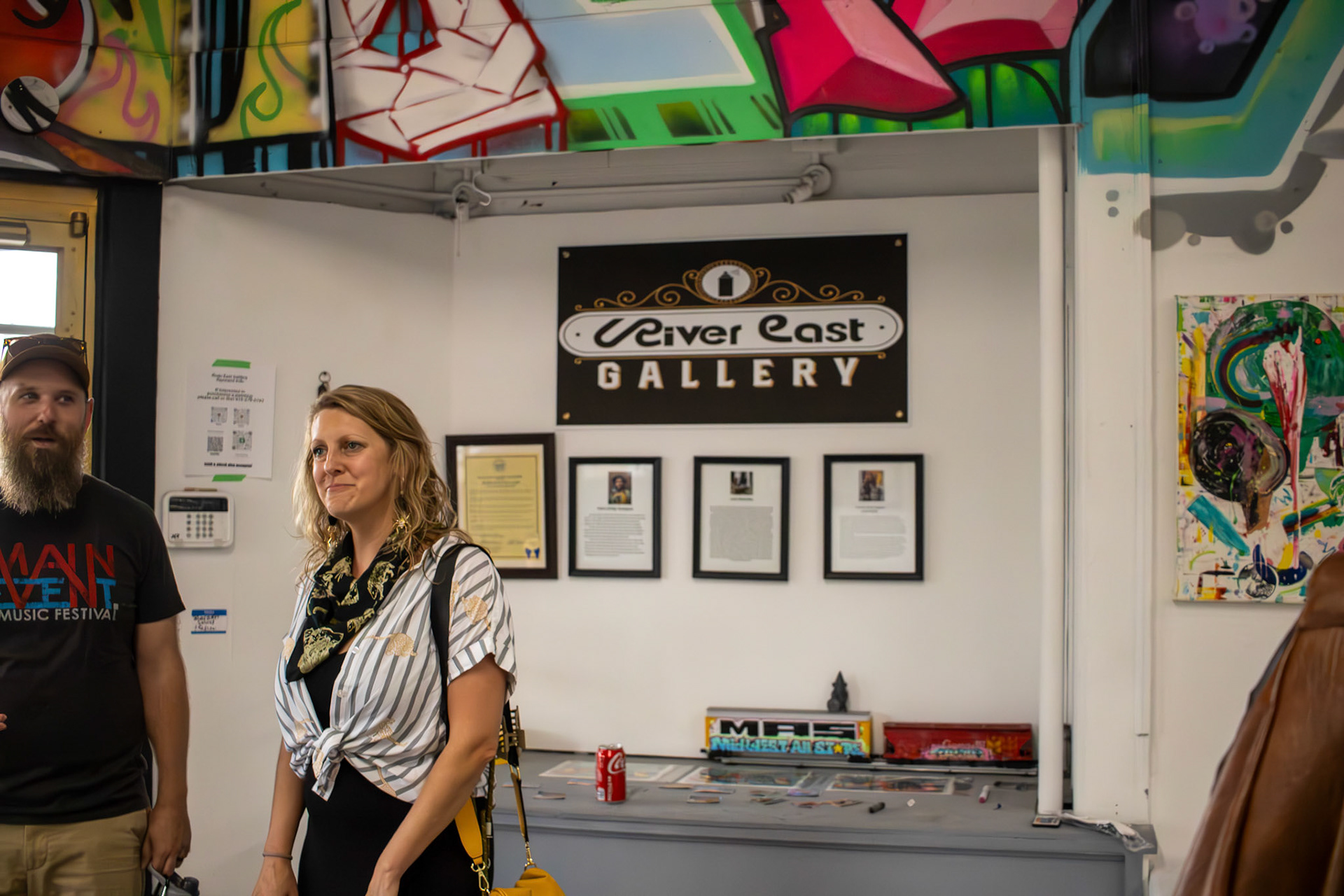 “Festival attendees and art lovers Brad Scherzer and Lindsay Williams admire the local work displayed in the River East Gallery”