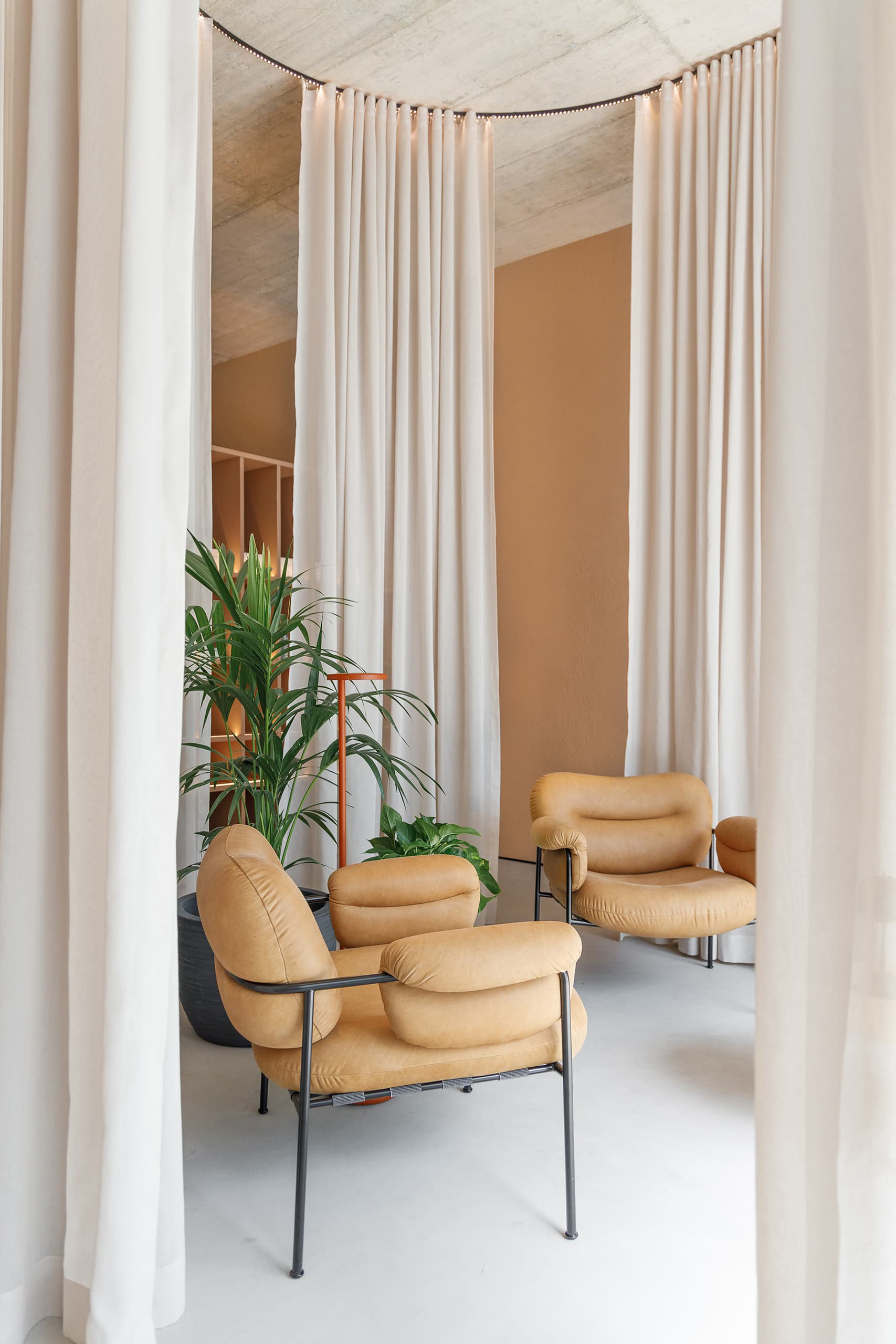 Waiting room area defined by curtains.