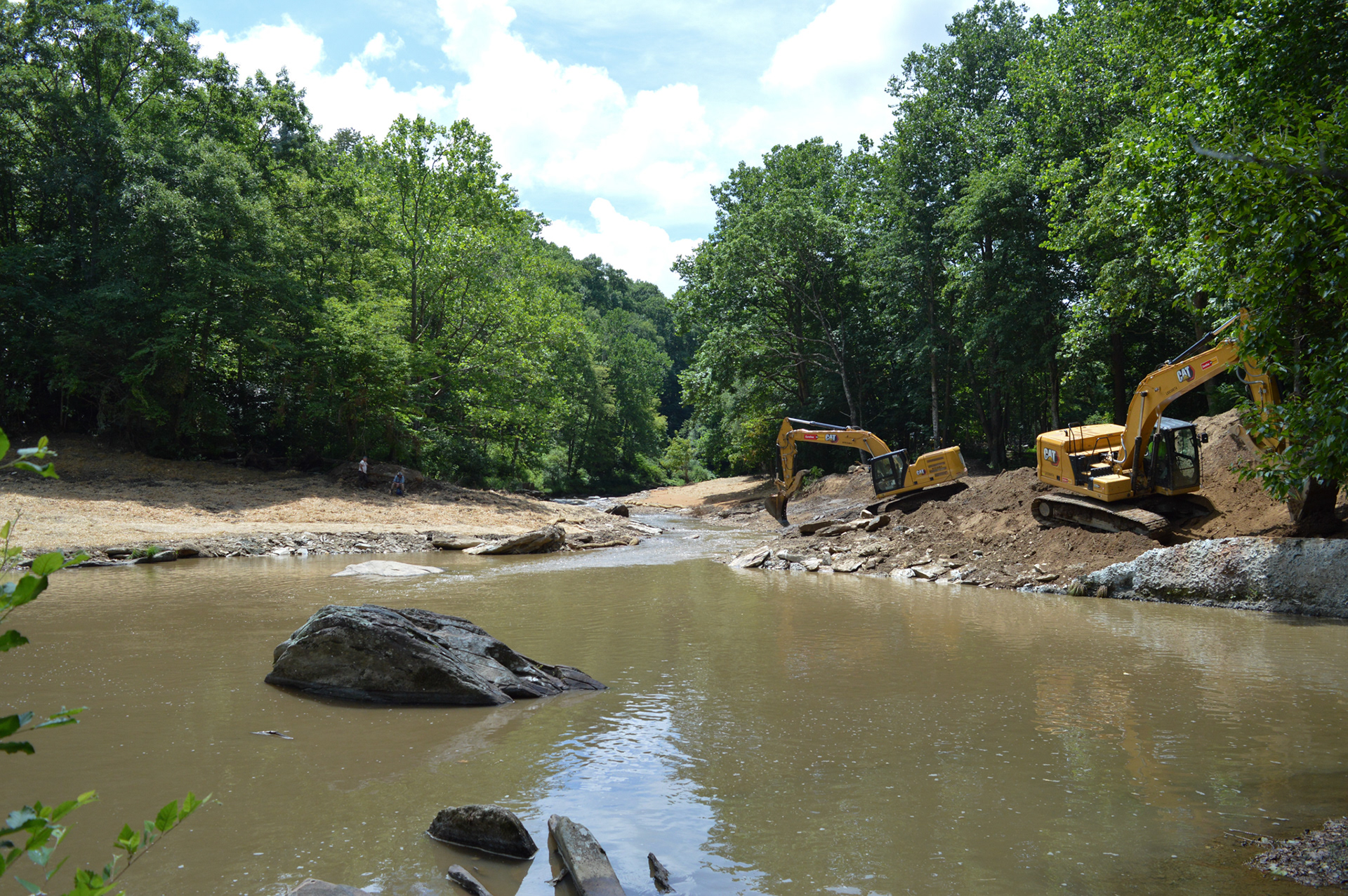 Excavators rest on the bank of the recently removed Shull's Mill Dam - 2024