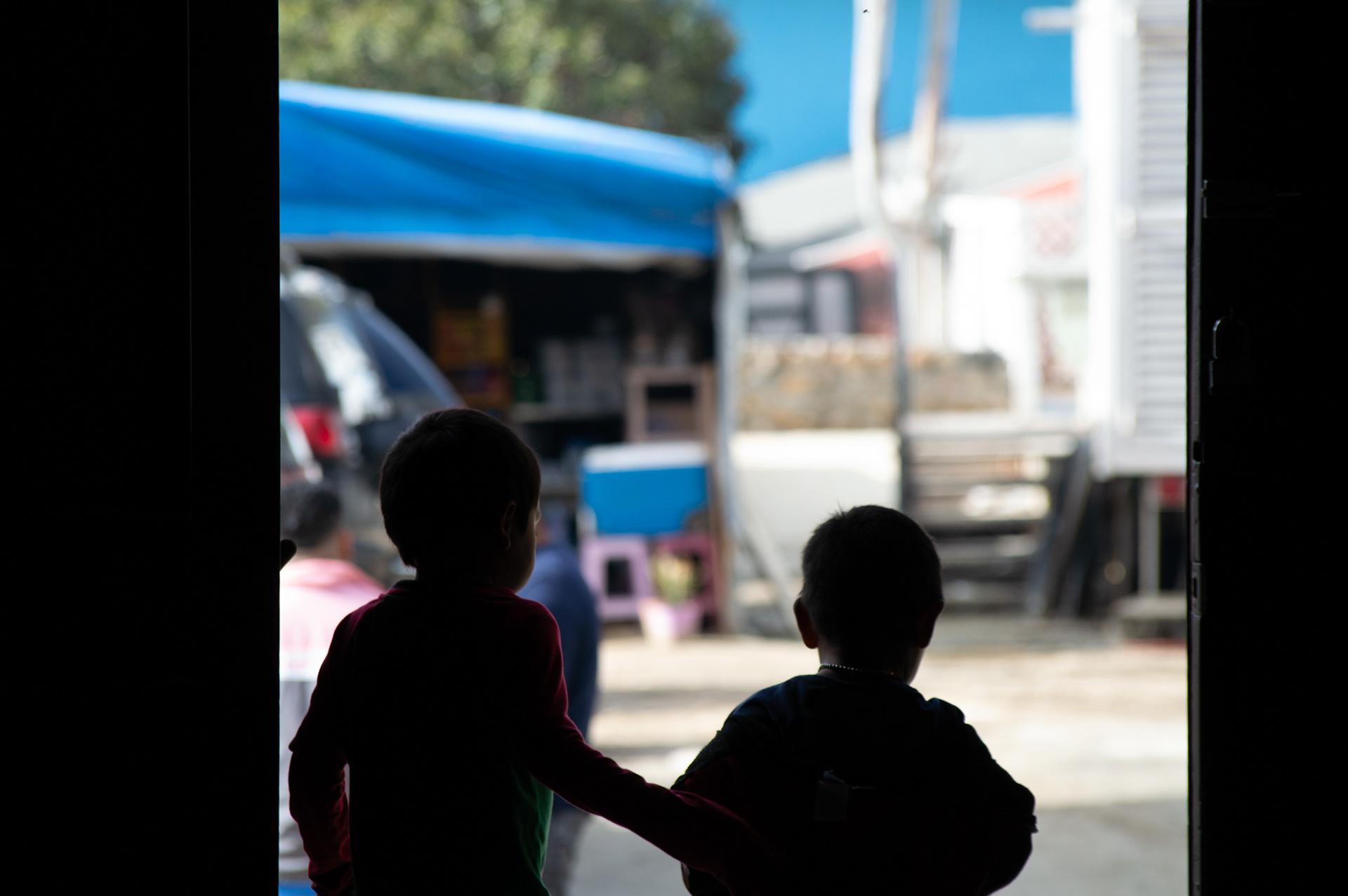 Children stand in the doorway of Templo Embajadores de Jesús, one of the largest shelters for immigrants traveling through Mexico.