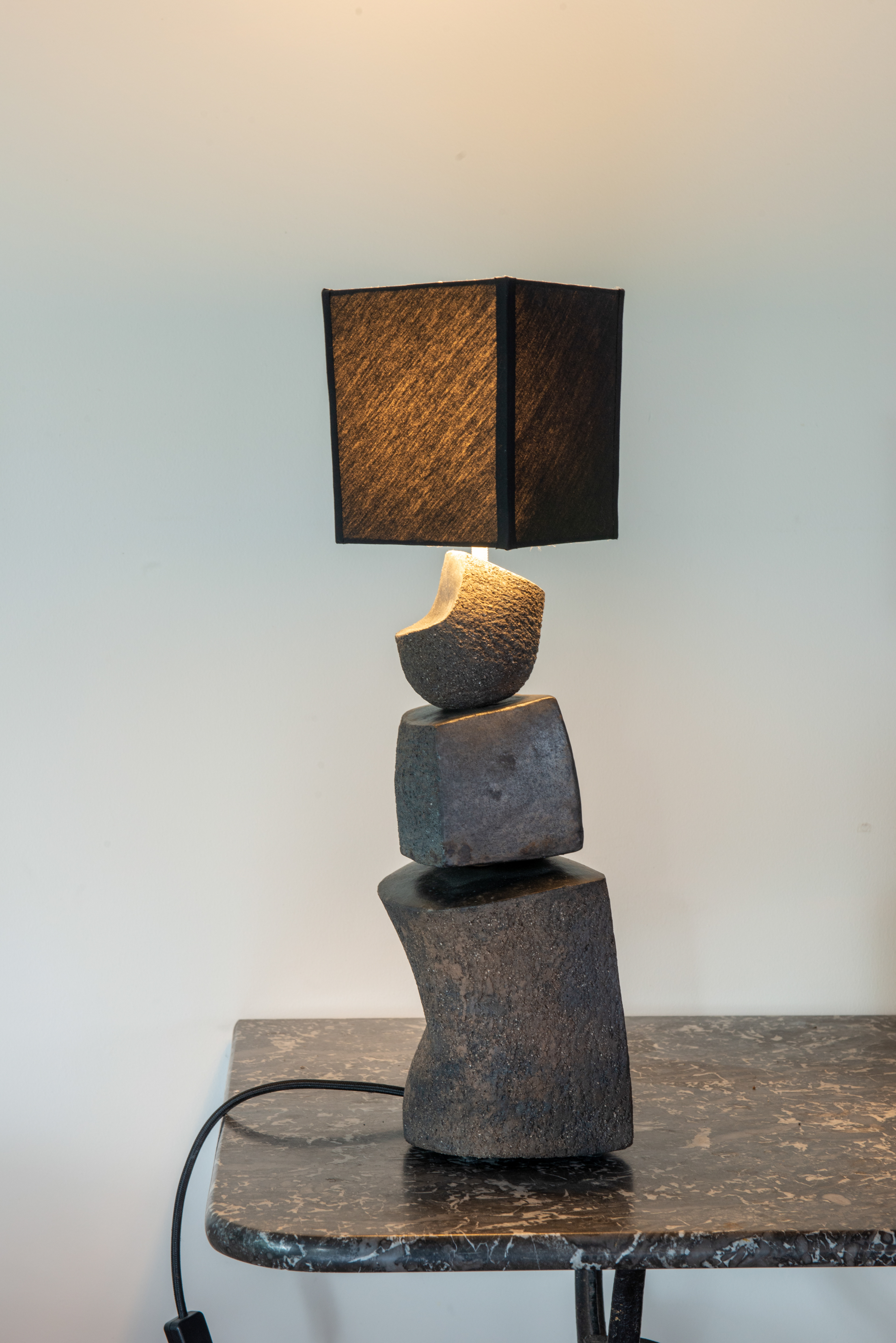 Terre grès noire, cuisson réduction en fosse. Abat-jour coton. H : 52cm