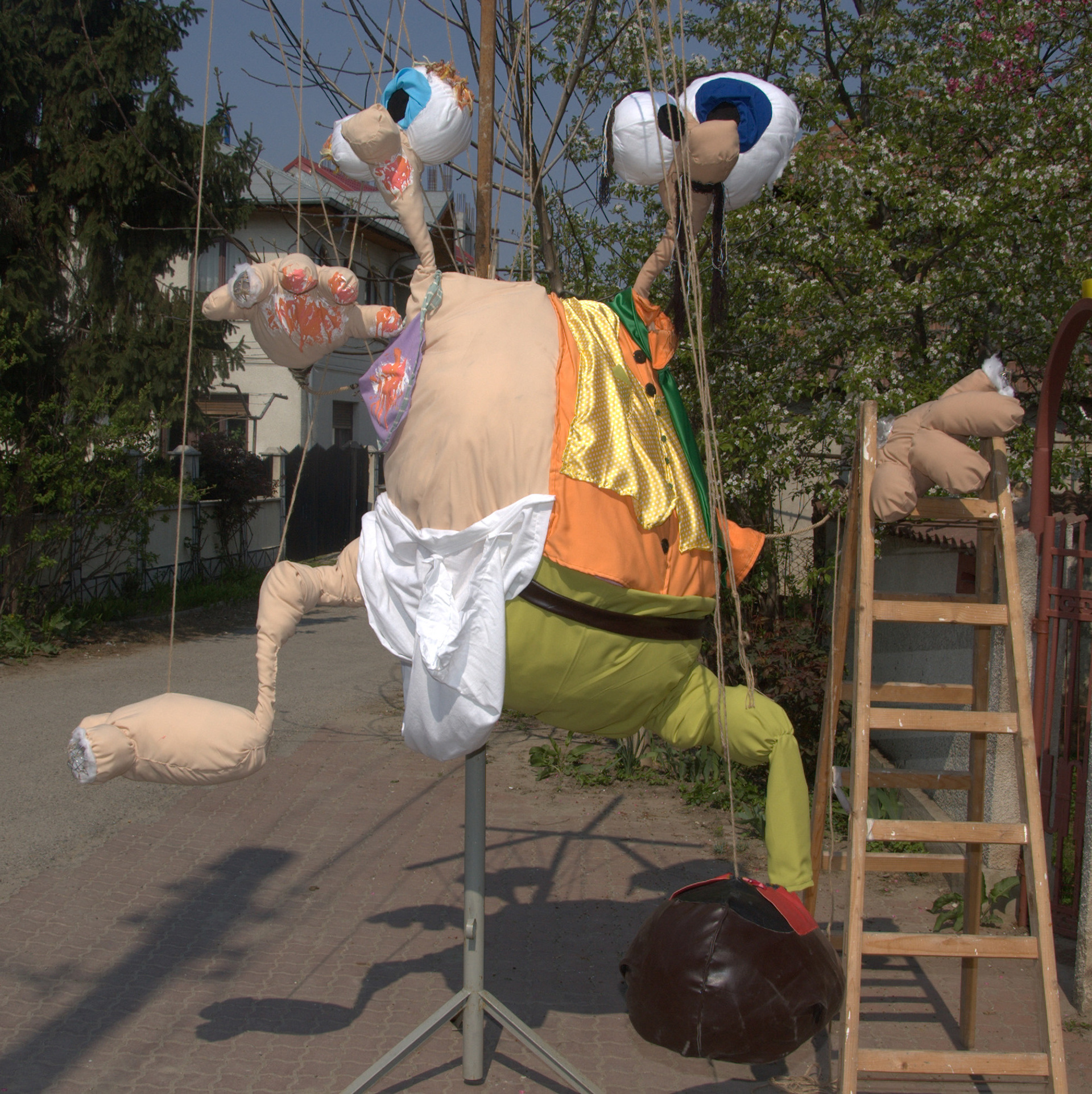 This is part of a group exhibition from 2009 called the "Comedy of Life". These huge marionette type objects suggest duality, evolution from child to adult and all the turmoil in between by trying to maintain creativity.