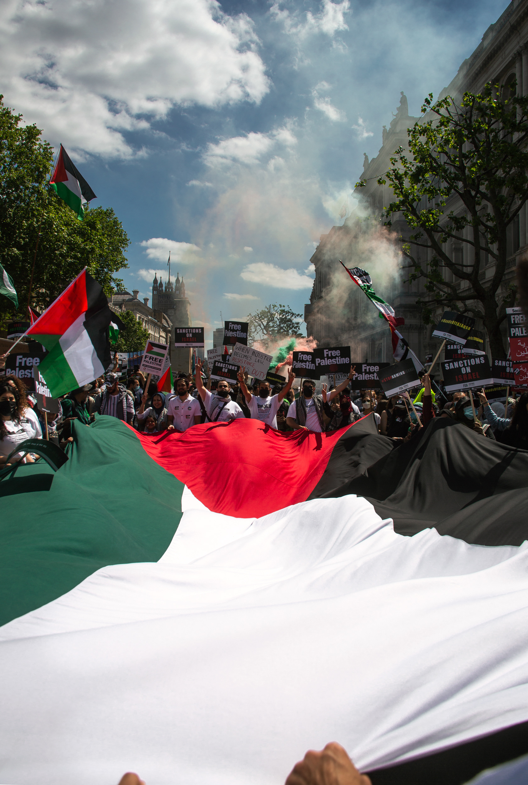 Protestors waving a massive Palestinian flag in front of 10 Downing Street as they voiced their anger with the UK's complicity in the occupation of Palestine. 12.06.2021. London, UK.
