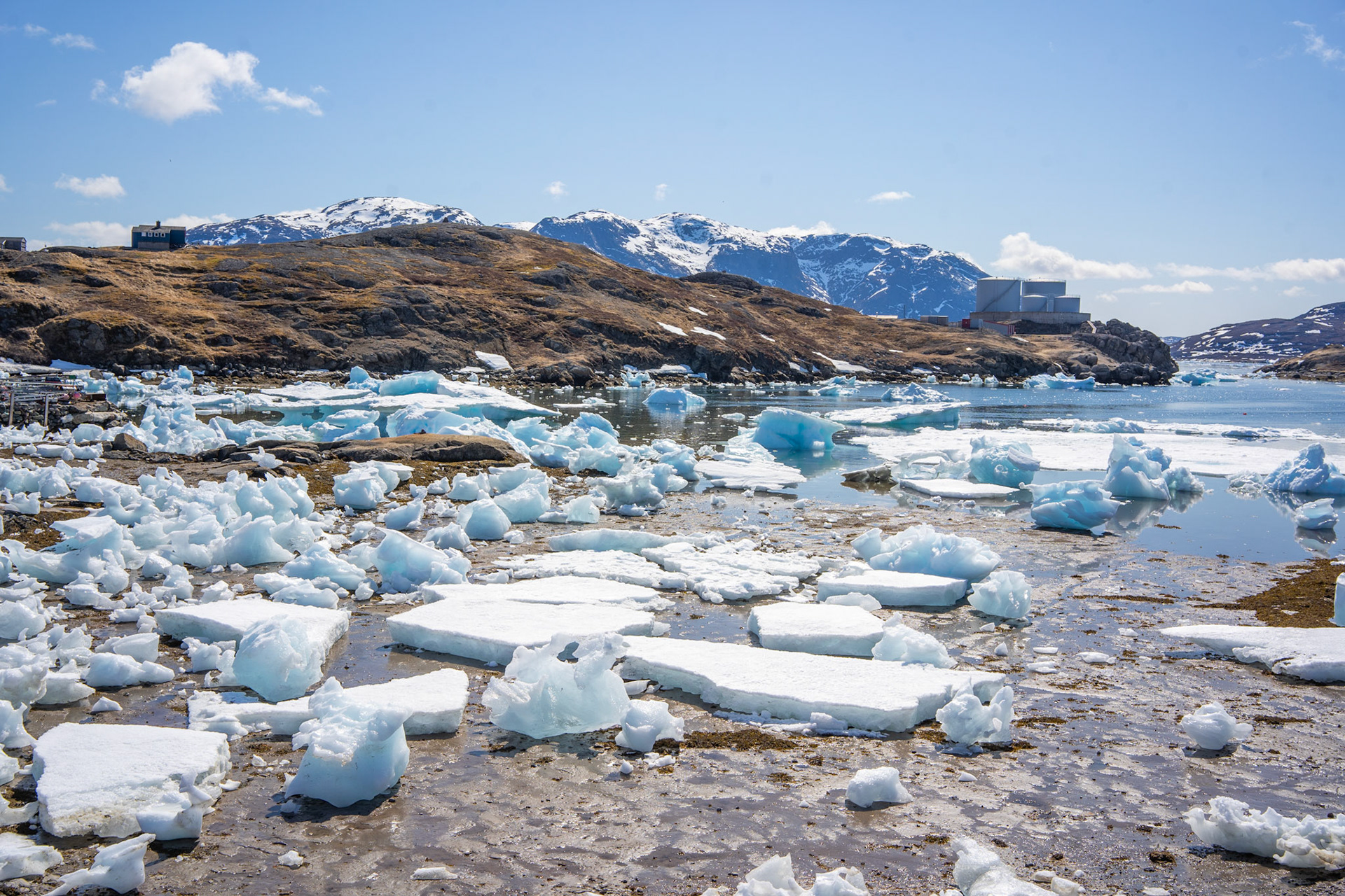 Low tide in the Narsaq harbor shows the difficulty of spring sailing in Tunulliarfik fjord.
