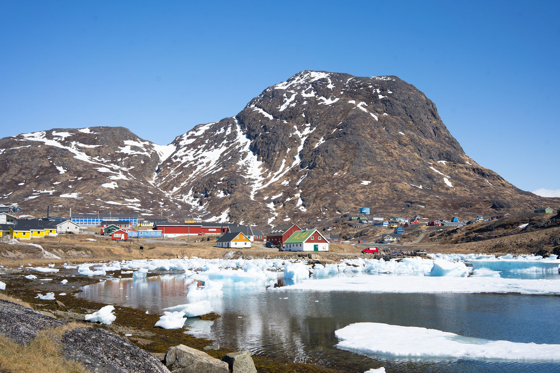 Narsaq in springtime, with Qaaqarsuaq ('big mountain') behind. This is the mountain that centered in the country's mining debate (Urani naamik), which was recently decided against opening the Qaaqarsuaq to uranium mining after strong protest from locals and farmers.