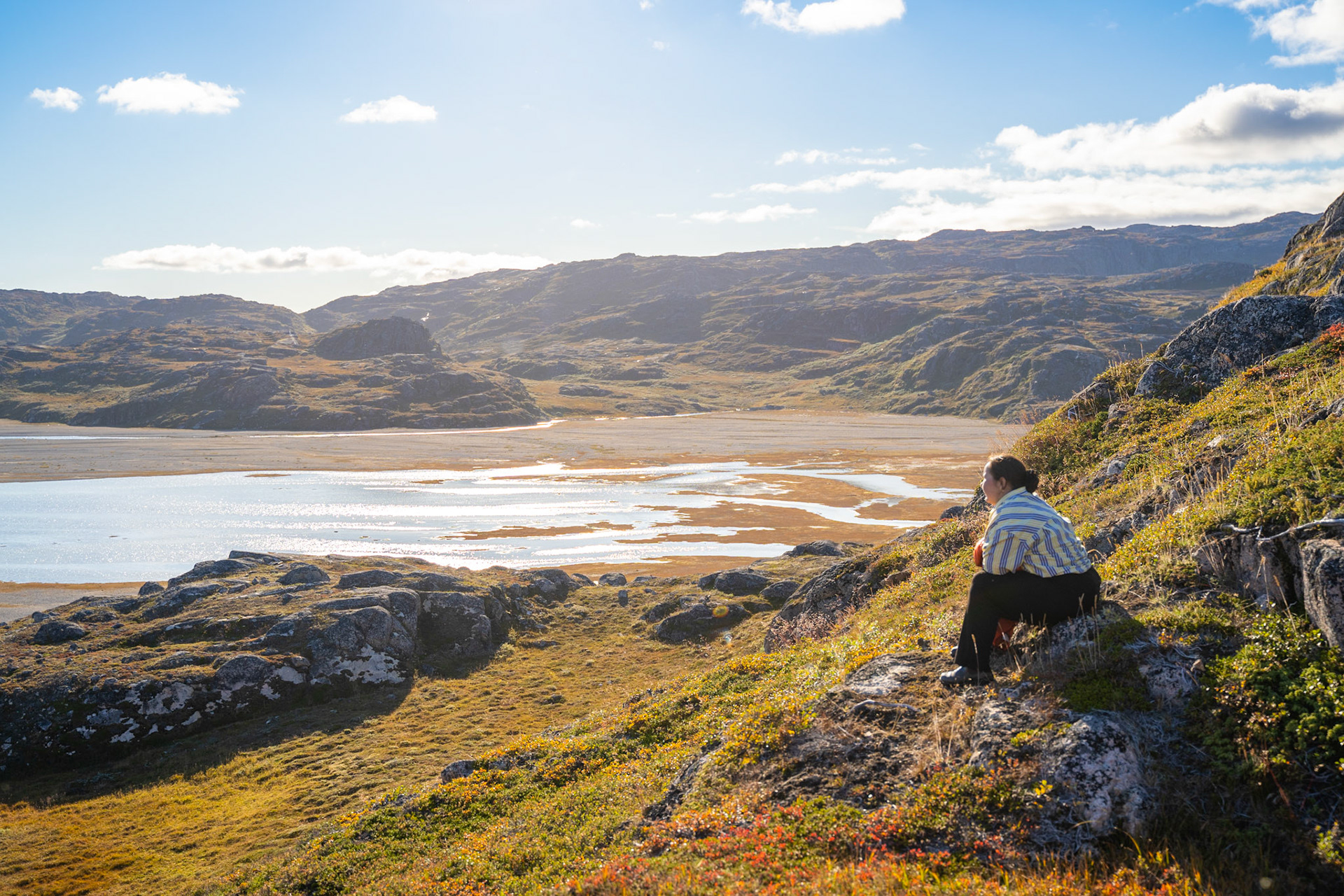 Freyja admiring the view. This is the second potential hay field Stefan asked us to check out. Carson and I were driven by Manitsioq and Freyja on their boat to the spot, and we all enjoyed the fresh air while I mapped the area.