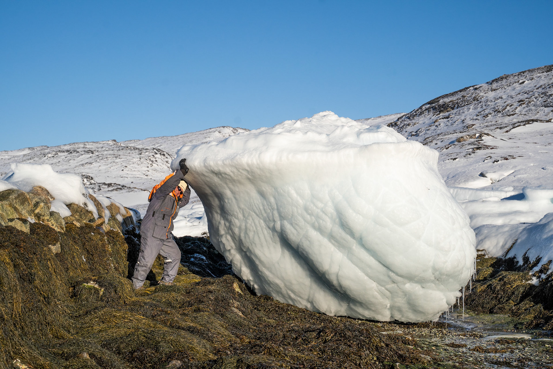 Pops with a big iceberg, stuck on the coast at low tide.