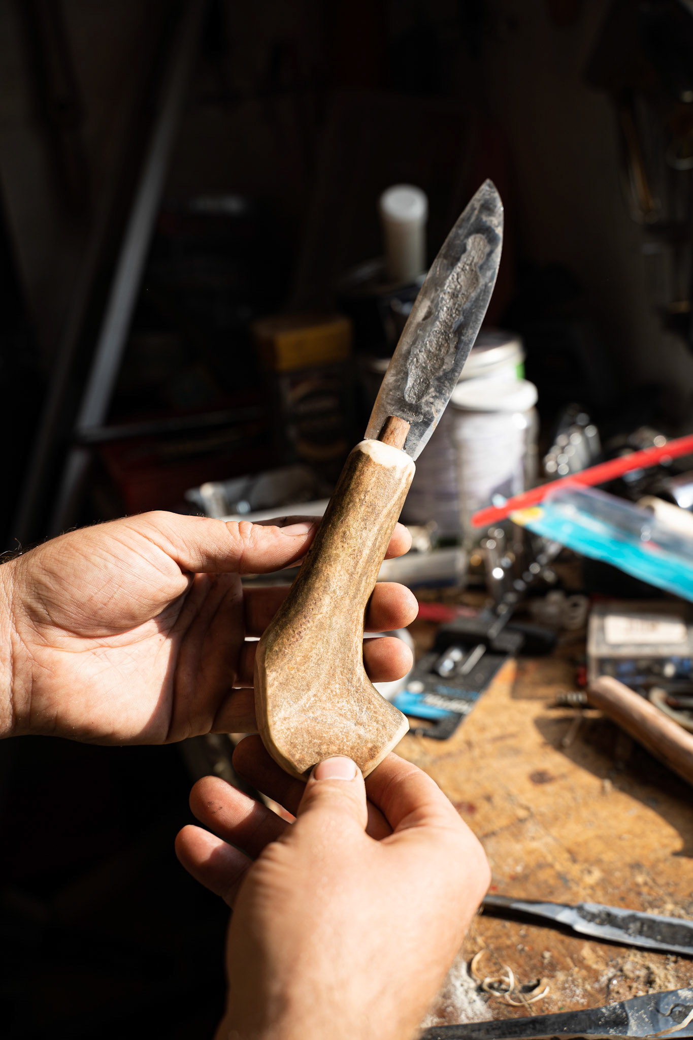 Stefan and Carson's forged knife made with an antler handle. The dented line in the blade curves it slightly, making the blade stronger.