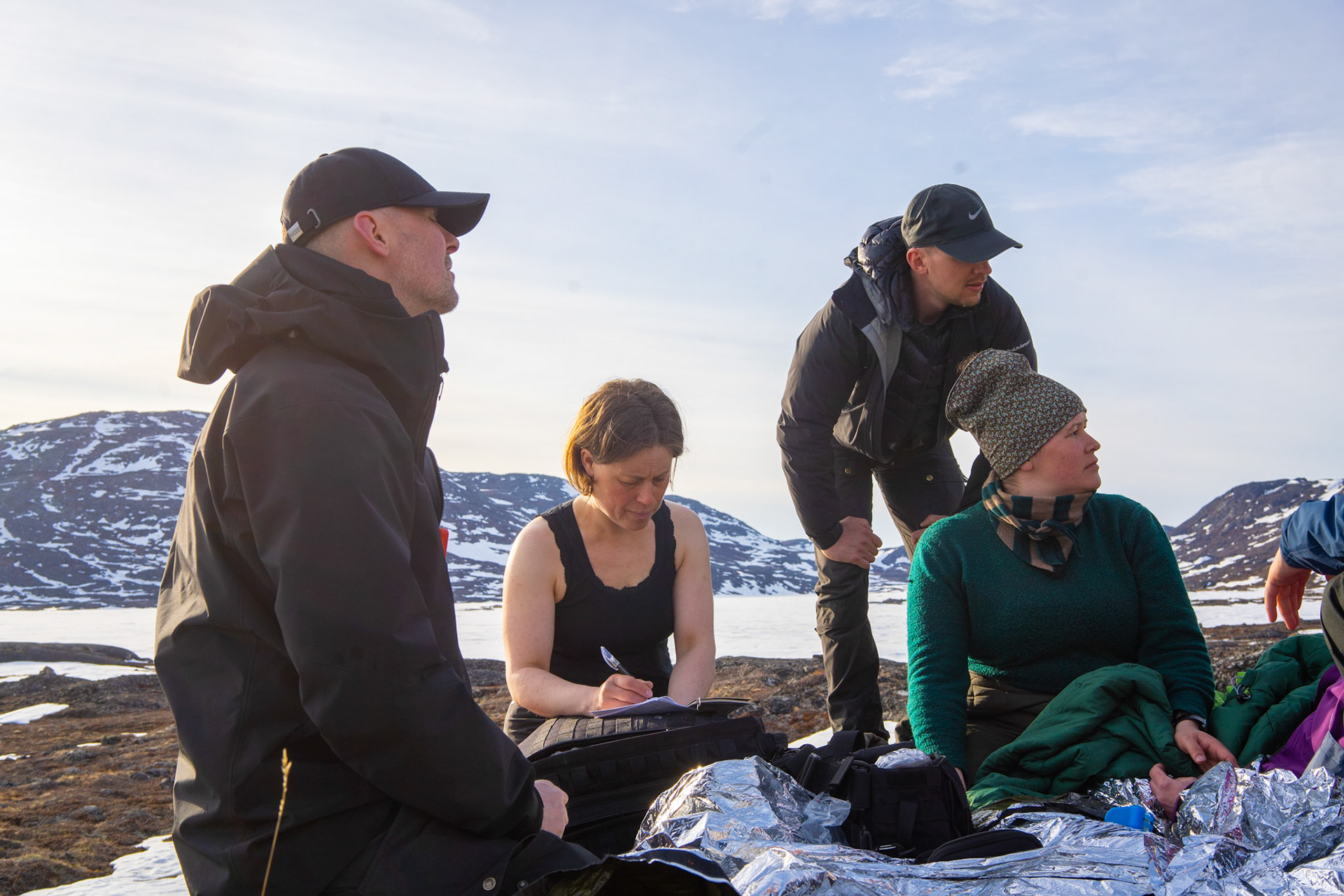 Niels, Aviaja, Lasse, and Heidi with a safety blanket. Aviaja demonstrating the cold tolerance of sheep farmers.