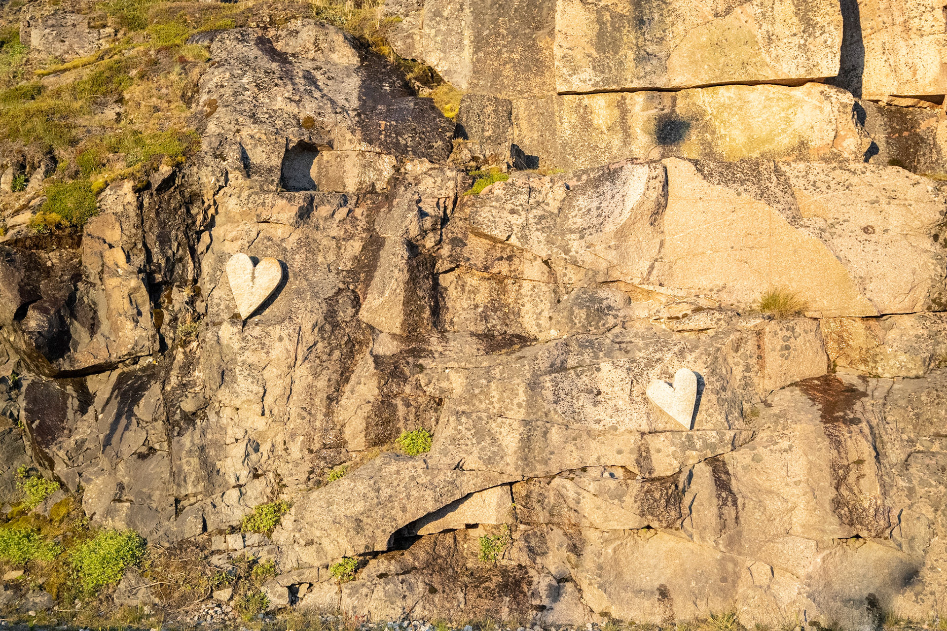 Hearts of stone, carved next to a walkway in Qaqortoq.