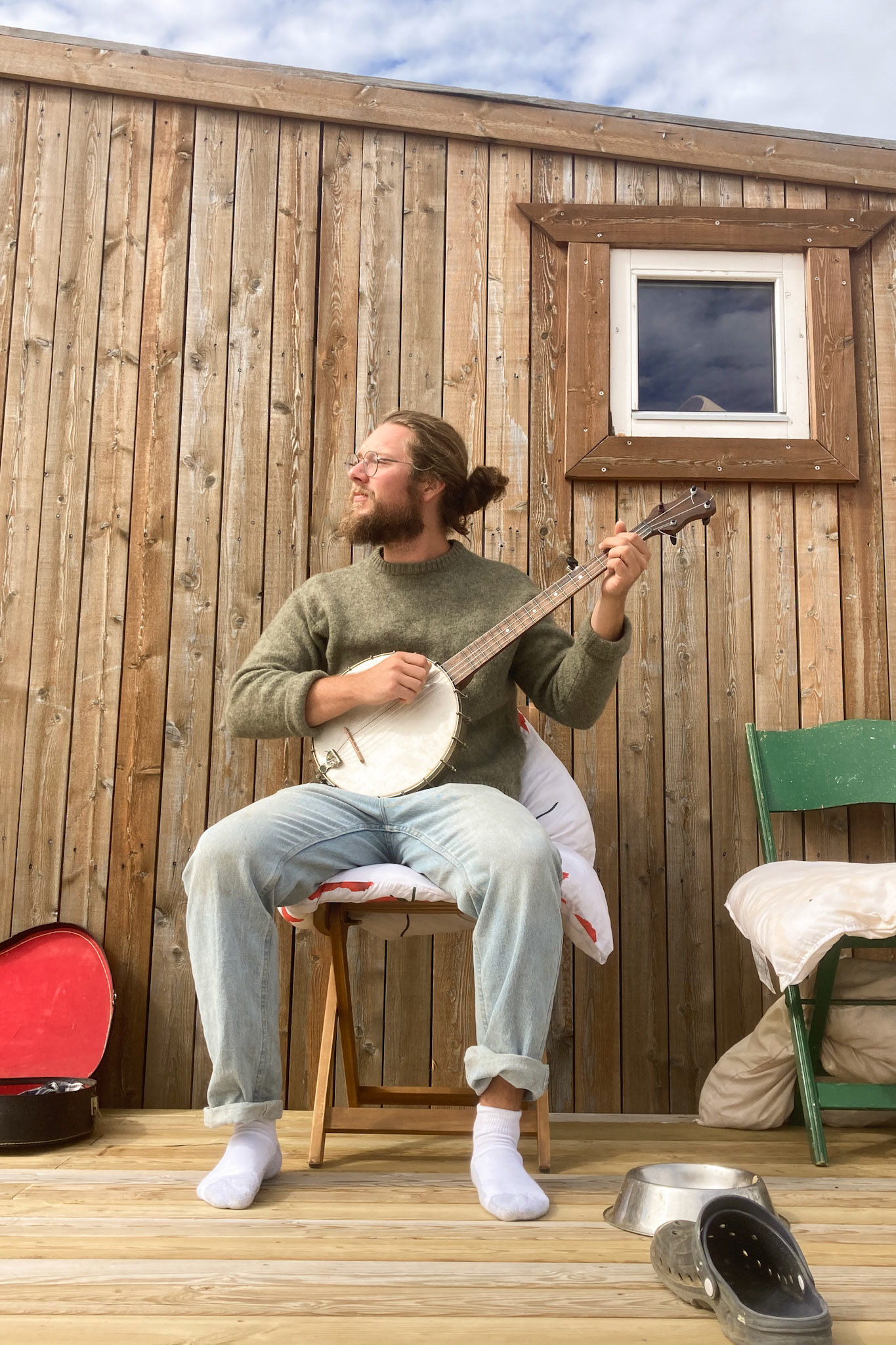 Carson on the porch, playing some banjo tunes on a late summer day. (Taken on my phone)