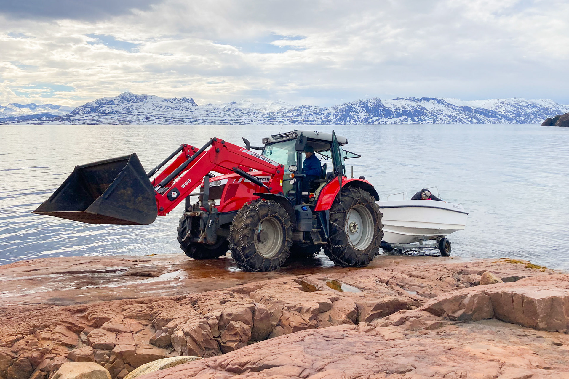 The boat is pulled up and down by the tractor every time it's used. This keeps it safe from storms and rrough water in the fjord. The rock forms a natural boat launch.
