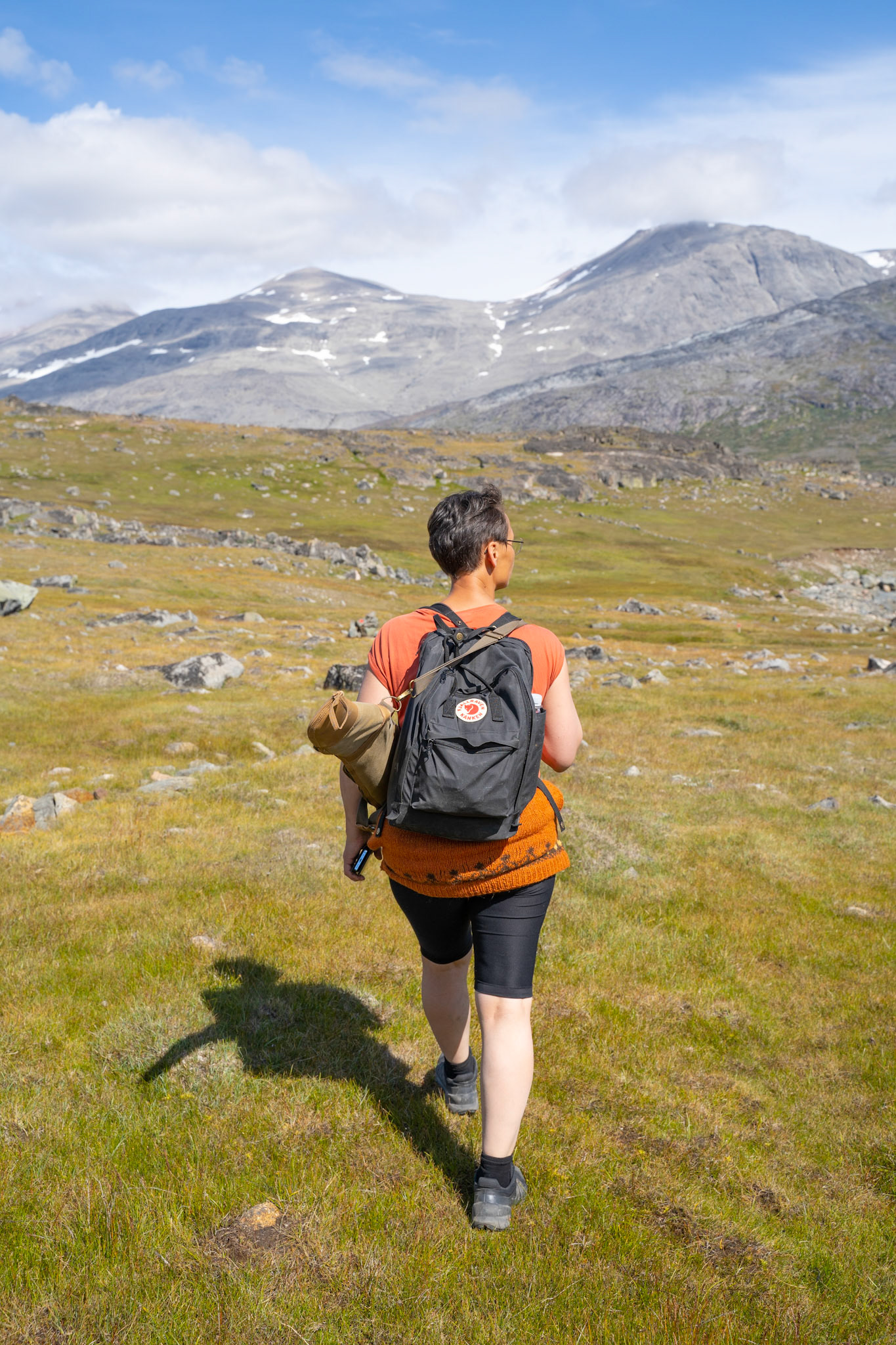 Arnaq hiking outside of Igaliku to look for undocumented ruins. She's carrrying her rifle because a polar bear was sighted near Igaliku the night prior.