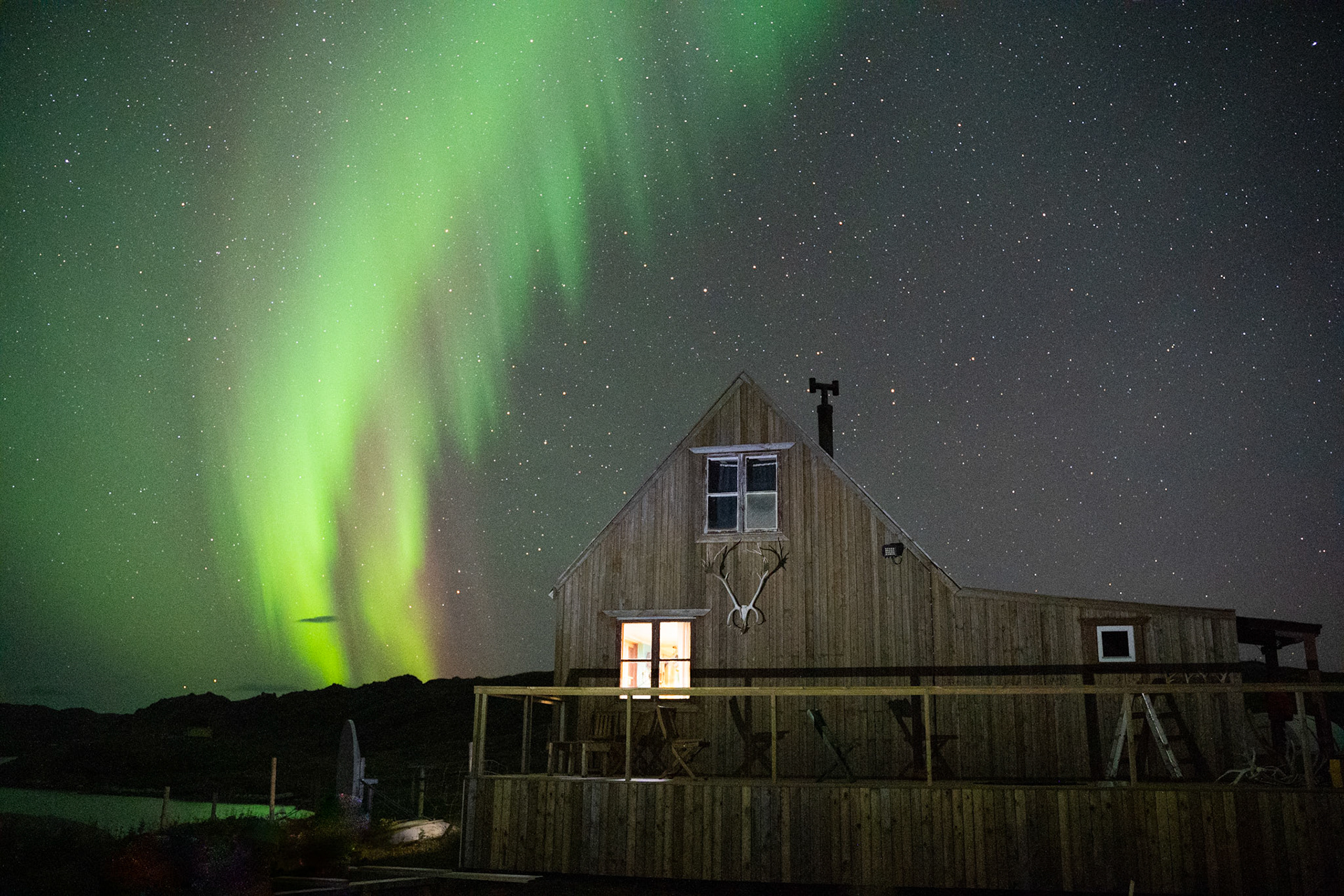 Northern lights and the station. This was the house I slept in and where we ate, talked, hung out, and had fires. (Photo by Carson Brown &amp; myself)