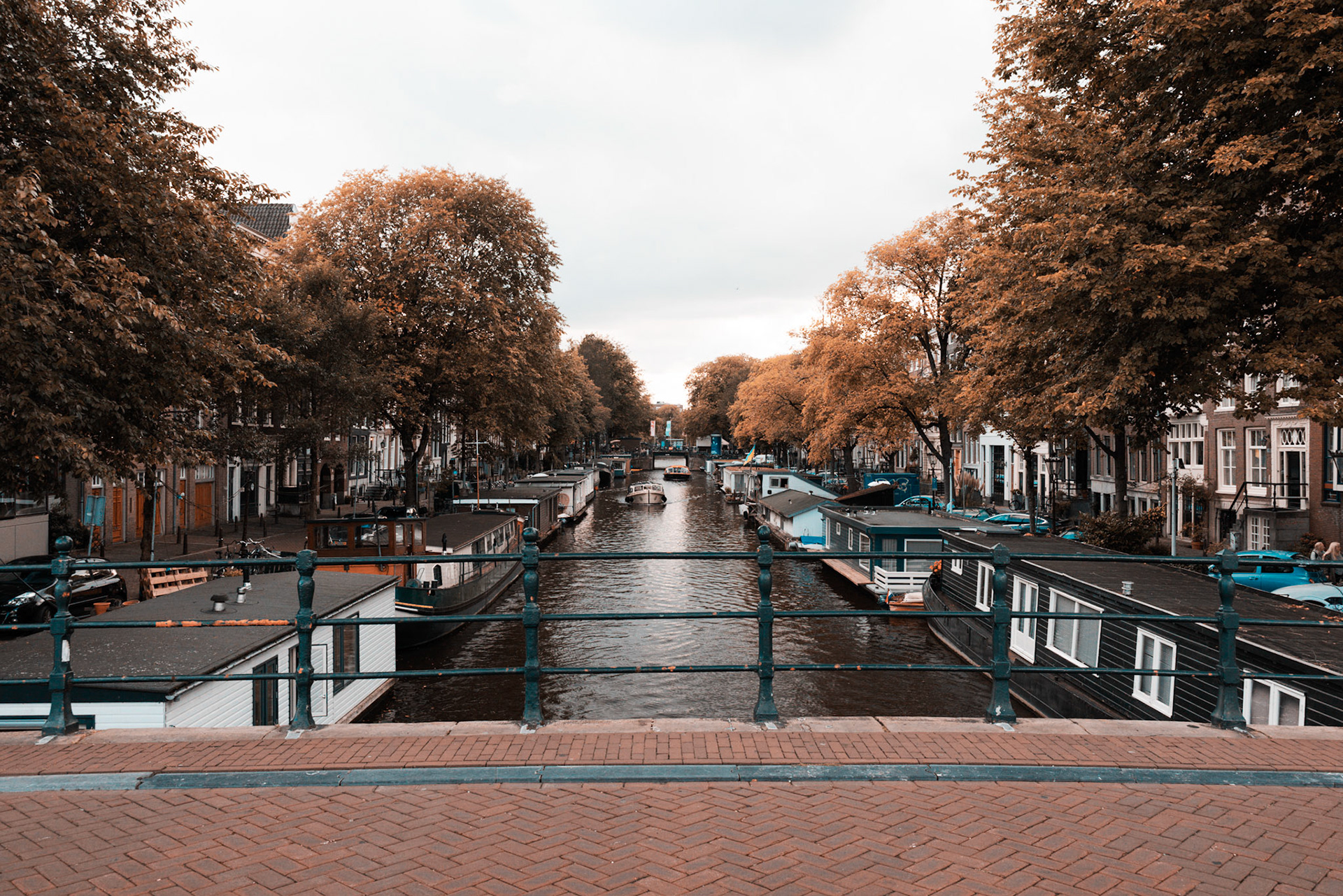 the classic view in Amsterdam on a canal with houseboats