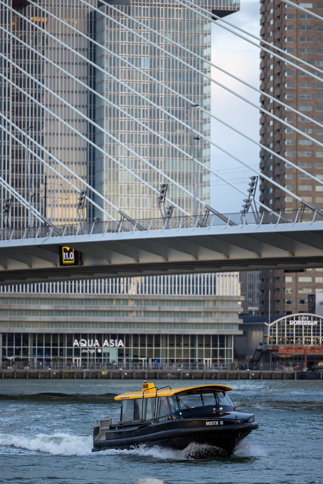 cab from Rotterdam in front of skyline and Erasmus bridge