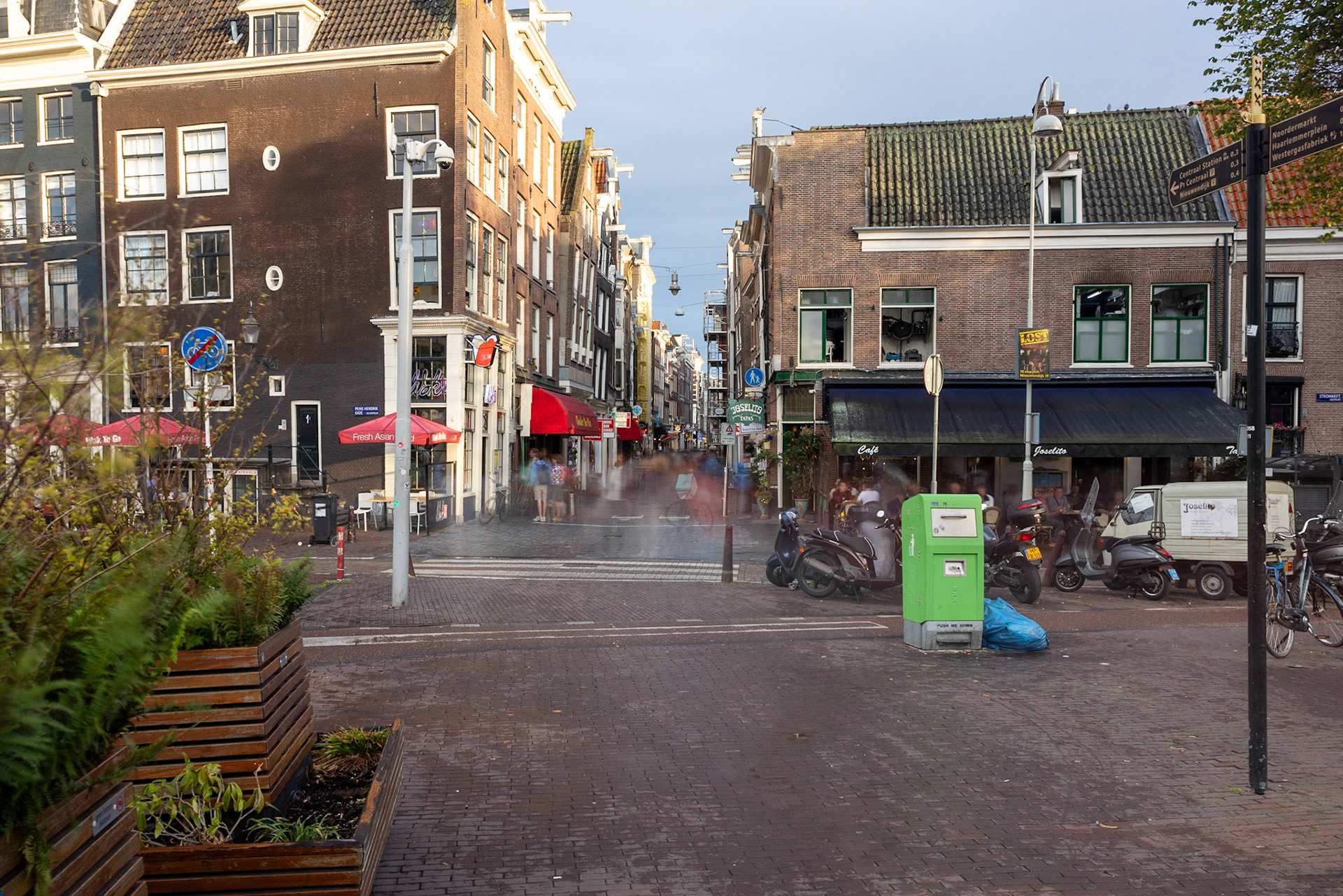 Long exposure showing the madness and speed of the city. The greening of the city stands next to mopeds bicycles and the tourist bustle.