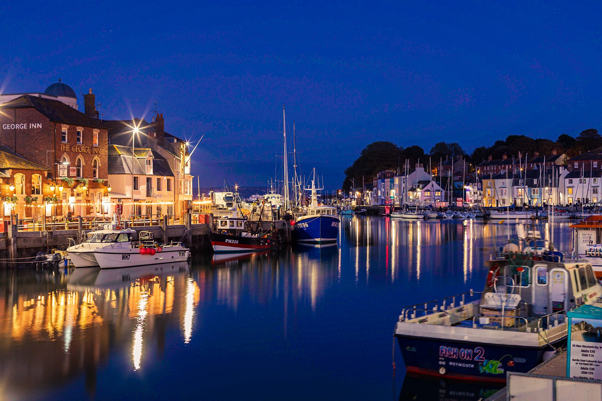 Weymouth’s famous vibrant harbour in the heart of the Jurassic Coast in Dorset as the sun sets and light turns to night in October