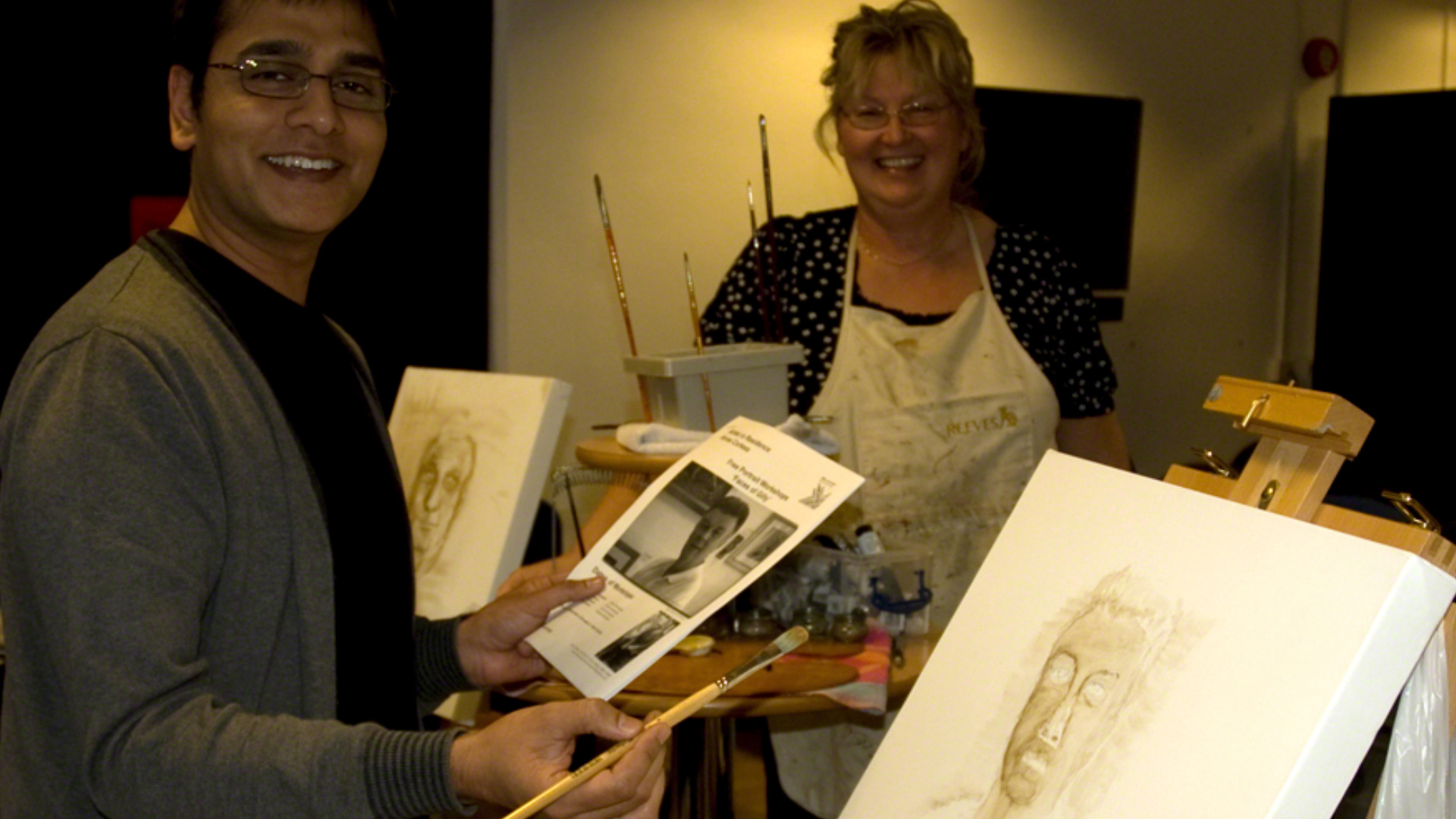 Anne Corless teaching BBC Radio Manchester presenter Talat Awan at BBC Radio Lancashire. 'Faces of Gilly' portrait art workshops with presenter John Gillmore. 2011.