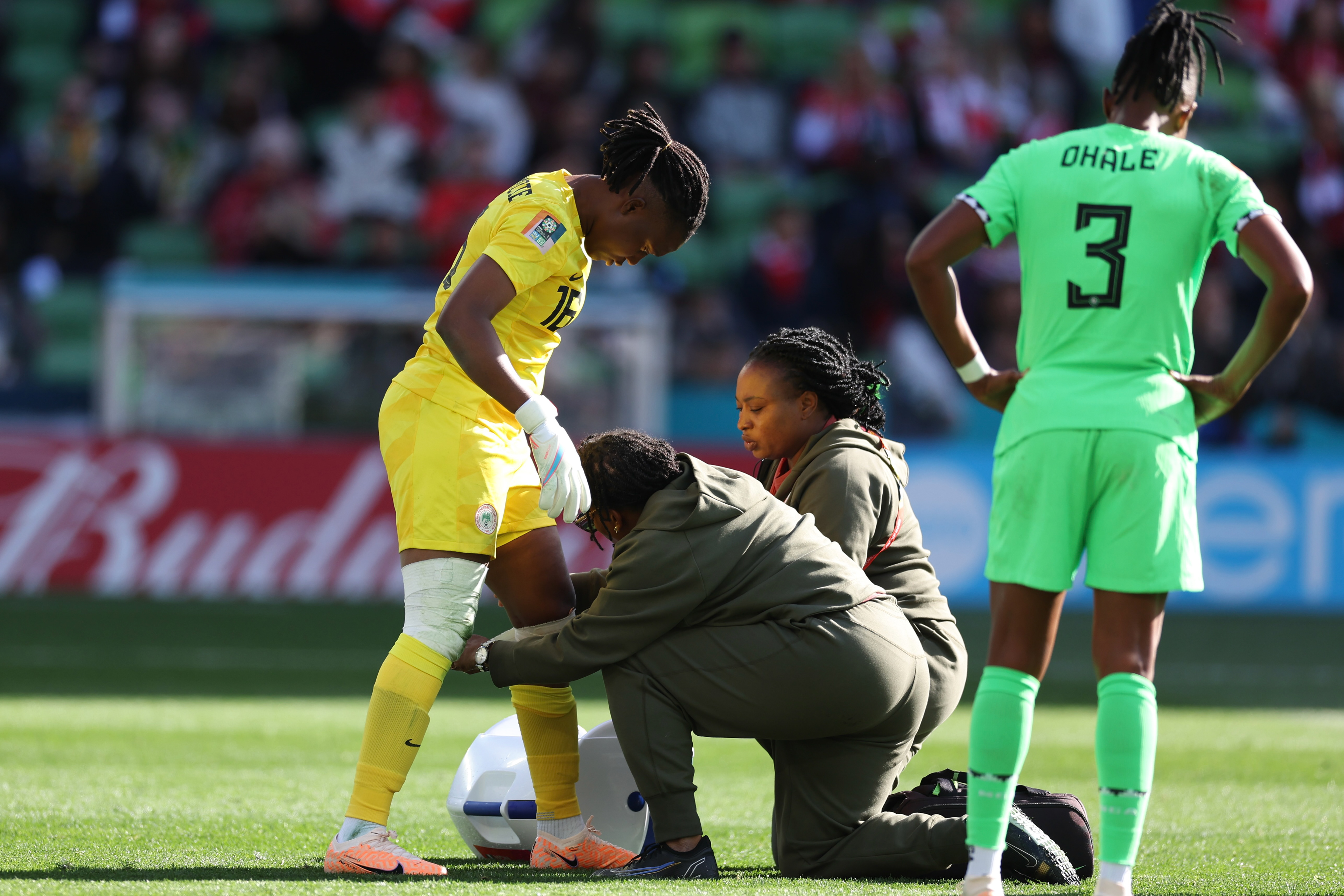 Nigeria's goalkeeper Chiamaka Nnadozie is treated by trainers during the Women's World Cup Group B soccer match between Nigeria and Canada in Melbourne, Australia, Friday, July 21, 2023. (AP Photo/Victoria Adkins)