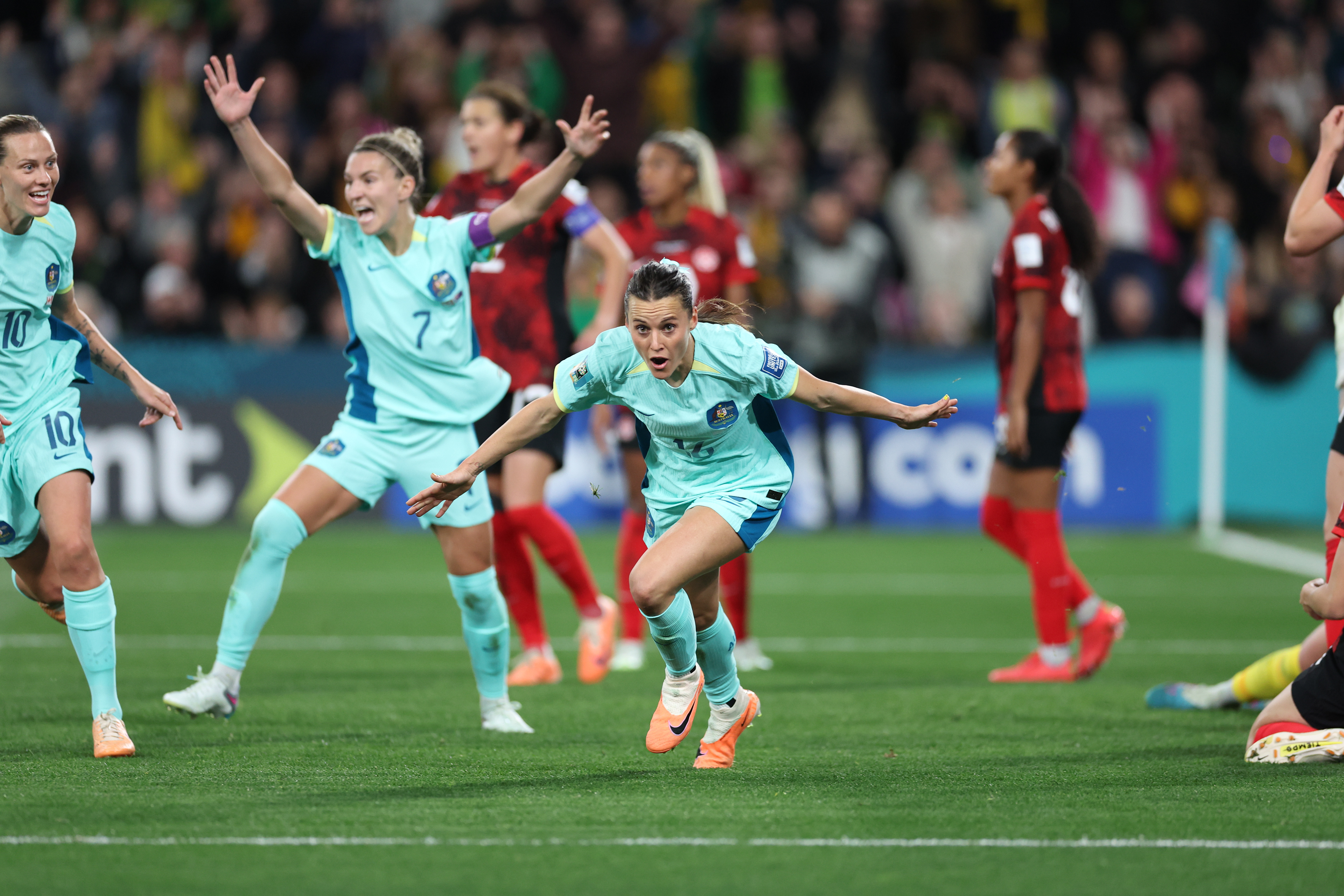 Australia's Hayley Raso, right, celebrates after scoring her side's second goal during the Women's World Cup Group B soccer match between Australia and Canada in Melbourne, Australia, Monday, July 31, 2023. (AP Photo/Victoria Adkins)