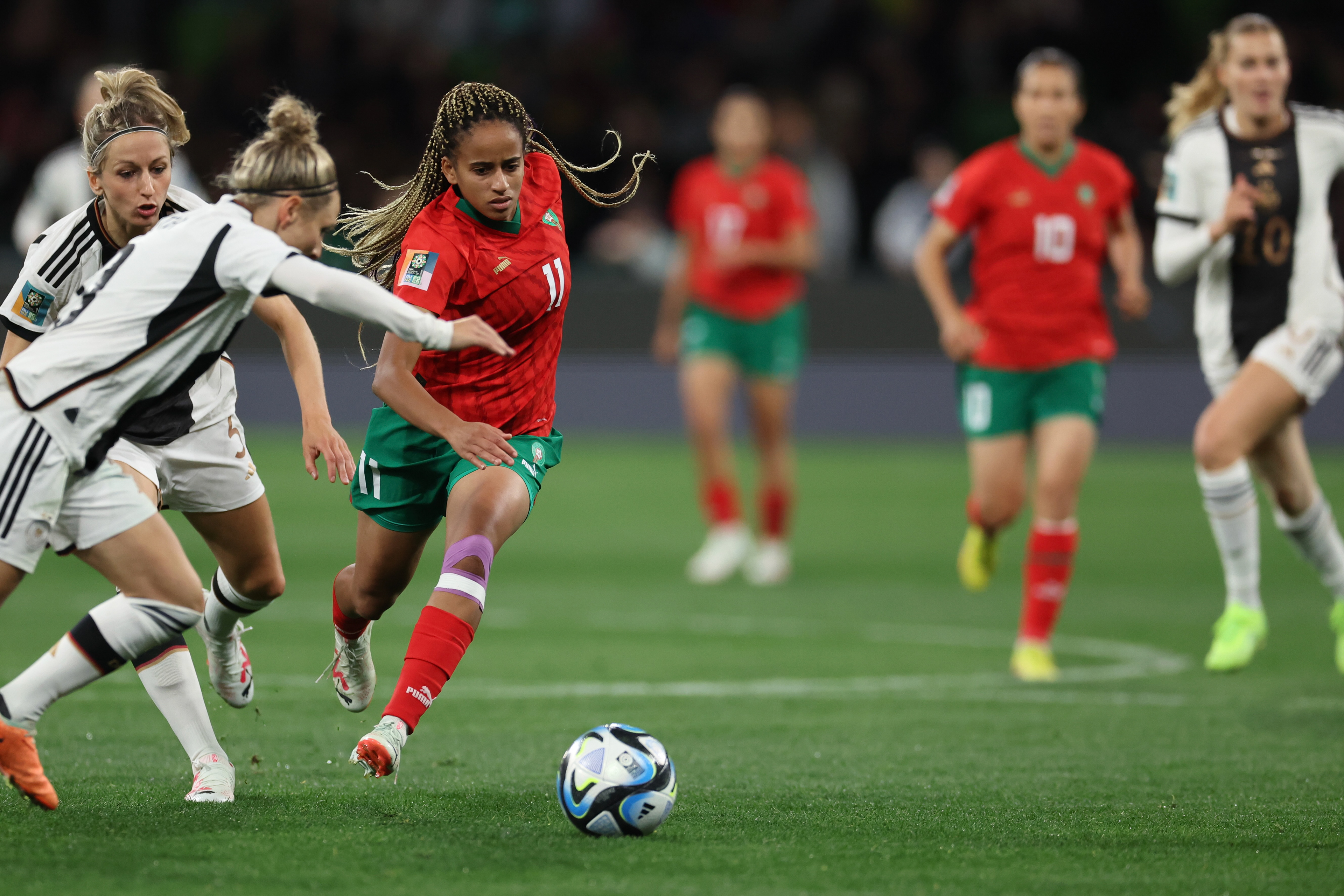 Morocco's Fatima Tagnaout, center, runs with the ball during the Women's World Cup Group H soccer match between Germany and Morocco in Melbourne, Australia, Monday, July 24, 2023. (AP Photo/Victoria Adkins)