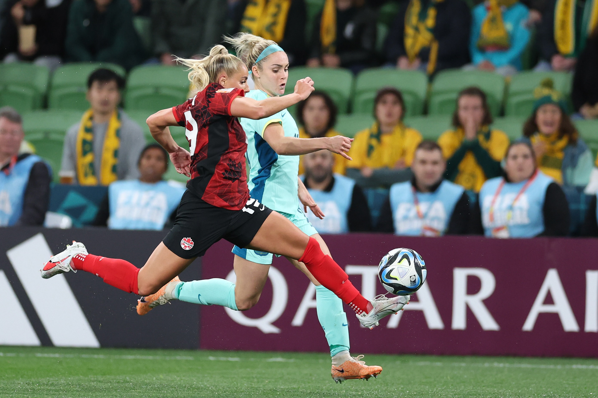 Canada's Adriana Leon, left, vies for the ball with Australia's Ellie Carpenter during the Women's World Cup Group B soccer match between Australia and Canada in Melbourne, Australia, Monday, July 31, 2023. (AP Photo/Victoria Adkins)