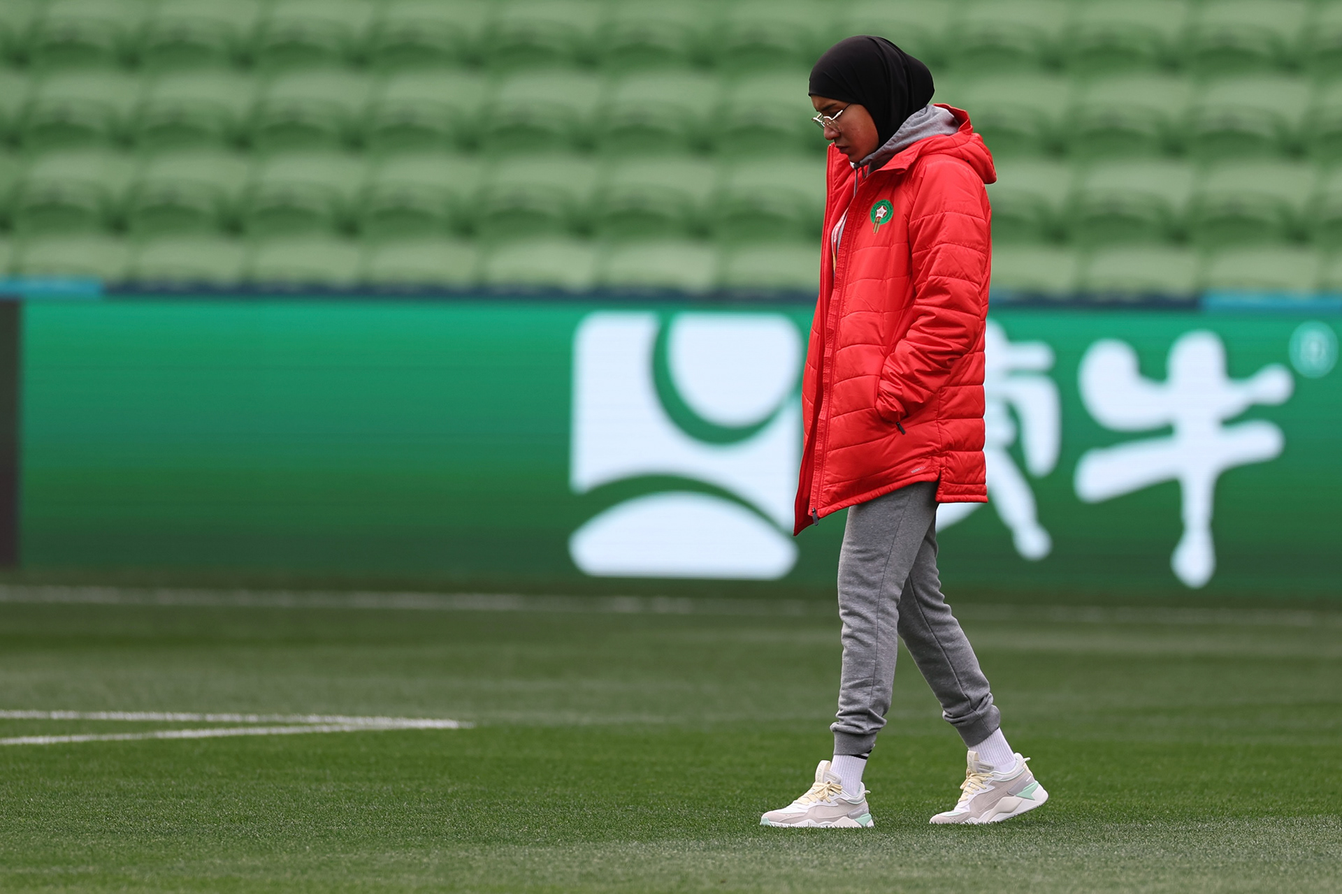 Morocco's Nouhaila Benzina walks around the ground during a familiarization tour ahead of her Women's World Cup Group H match with Germany in Melbourne, Australia, on Sunday, July 23, 2023. When Benzina steps onto the pitch Monday evening, she will be first player to compete in a senior-level FIFA Women's World Cup wearing a hijab. (AP Photo/Victoria Adkins)