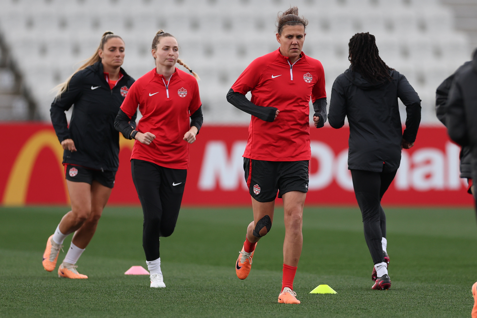 Canadian players train ahead of a match against Australia at the Women's World Cup in Melbourne, Australia, Sunday, July 30, 2023. The last time Canada played a high-stakes international match, for the 2020 Olympic gold medal, it was in an eerily empty stadium. On Monday night, in a pivotal Women's World Cup match against tournament co-host Australia, Canada is expecting a very different environment –- a stadium full of the opposing team's fans. (AP Photo/Victoria Adkins)