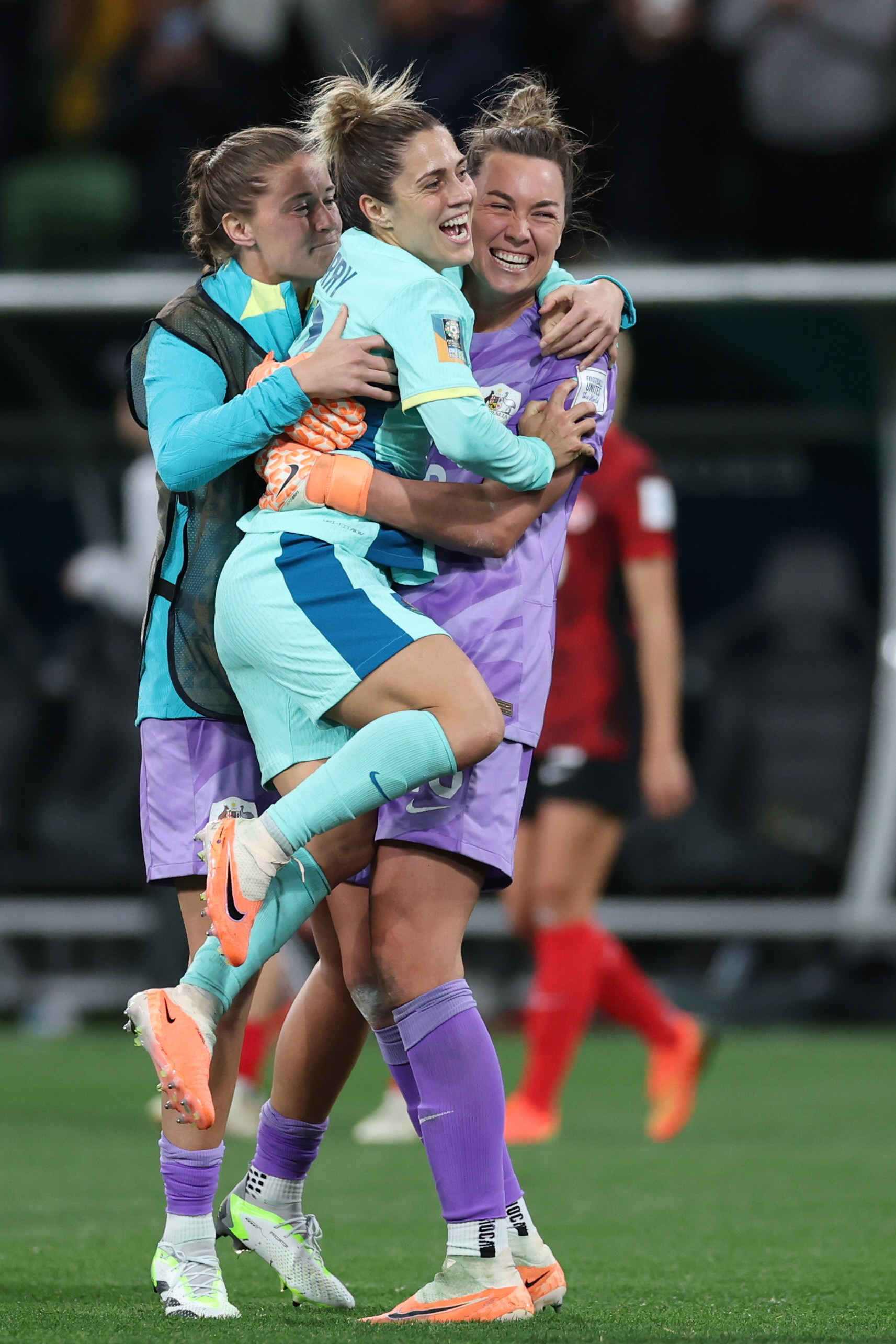 Australia's Katrina Gorry leaps into the arms of goalkeeper Mackenzie Arnold celebrating at the end of the Women's World Cup Group B soccer match between Australia and Canada in Melbourne, Australia, Monday, July 31, 2023. Australia won 4-0. (AP Photo/Victoria Adkins)
