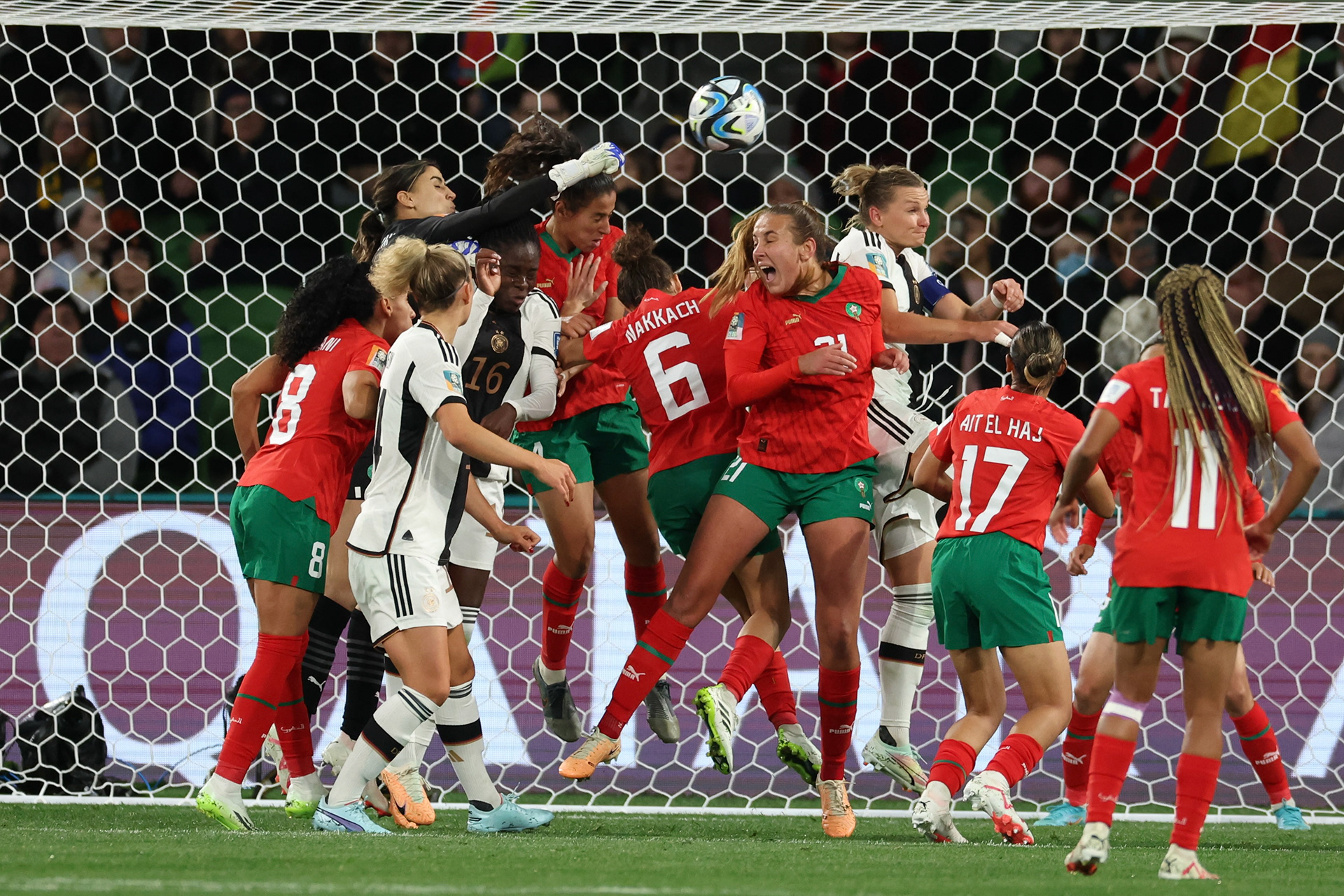 Morocco's goalkeeper Khadija Er-Rmichi tries to punch the ball away as players collide in front of the Moroccan net, leading to an own goal, during the Women's World Cup Group H soccer match between Germany and Morocco in Melbourne, Australia, Monday, July 24, 2023. (AP Photo/Victoria Adkins)
