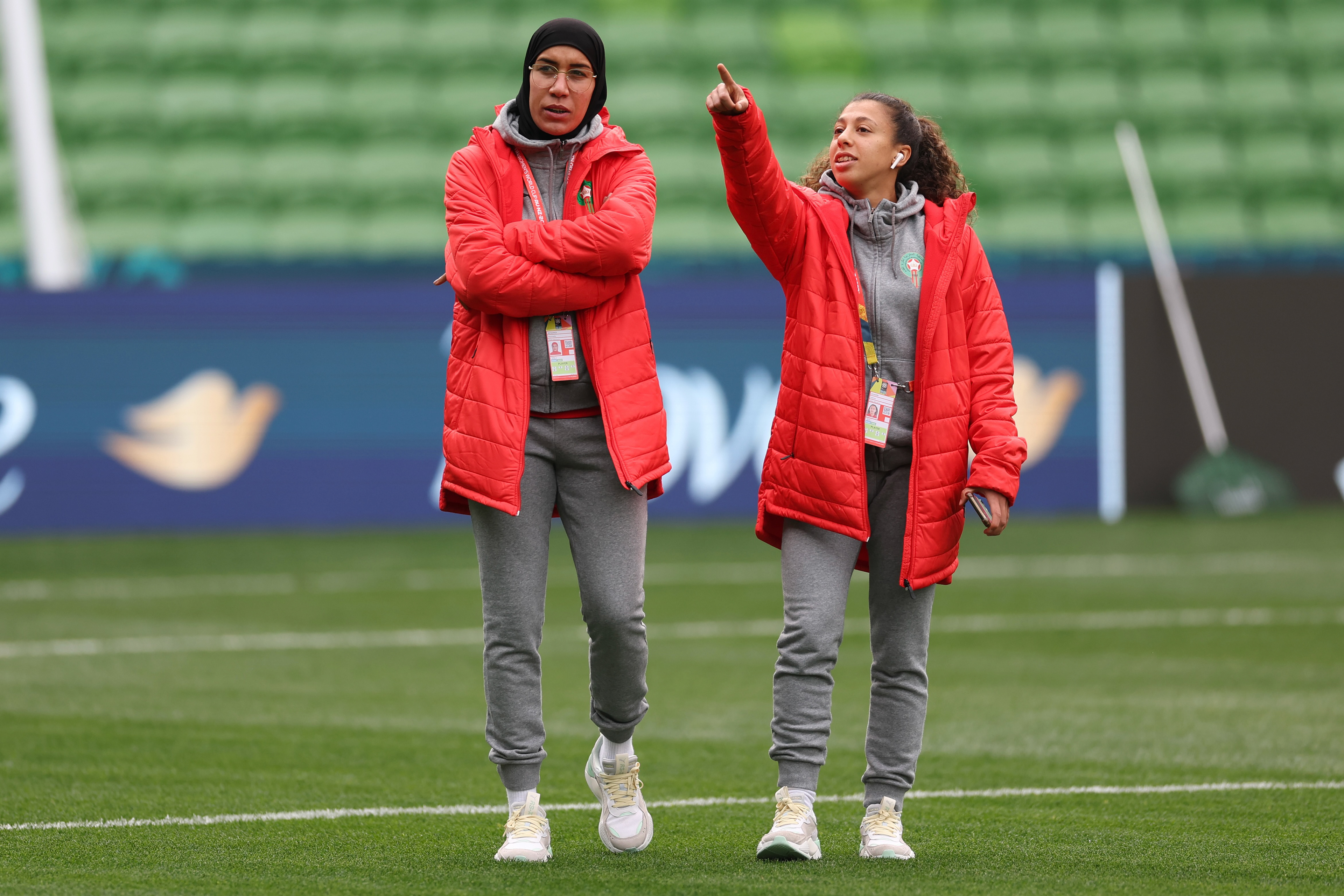 Morocco's Nouhaila Benzina, left, and Fatima Gharbi walk around the ground during a familiarization tour ahead of their Women's World Cup Group H match against Germany in Melbourne, Australia, Sunday, July 23, 2023. When Benzina steps onto the pitch Monday evening, she will be first player to compete in a senior-level FIFA Women's World Cup wearing a hijab. (AP Photo/Victoria Adkins)