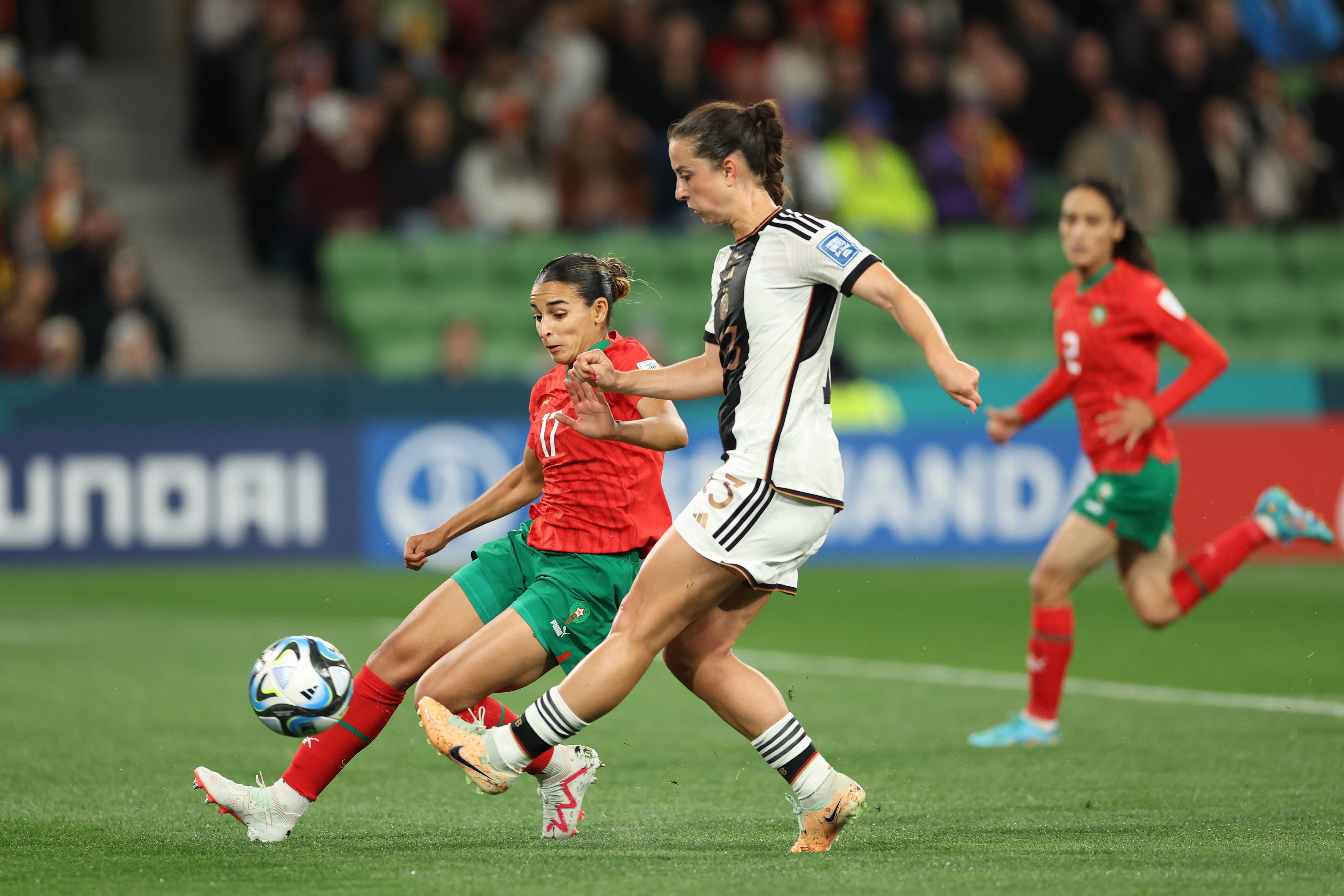 Germany's Sara Daebritz clears the ball away from Morocco's Hanane Ait El Haj, left, during the Women's World Cup Group H soccer match between Germany and Morocco in Melbourne, Australia, Monday, July 24, 2023. (AP Photo/Victoria Adkins)
