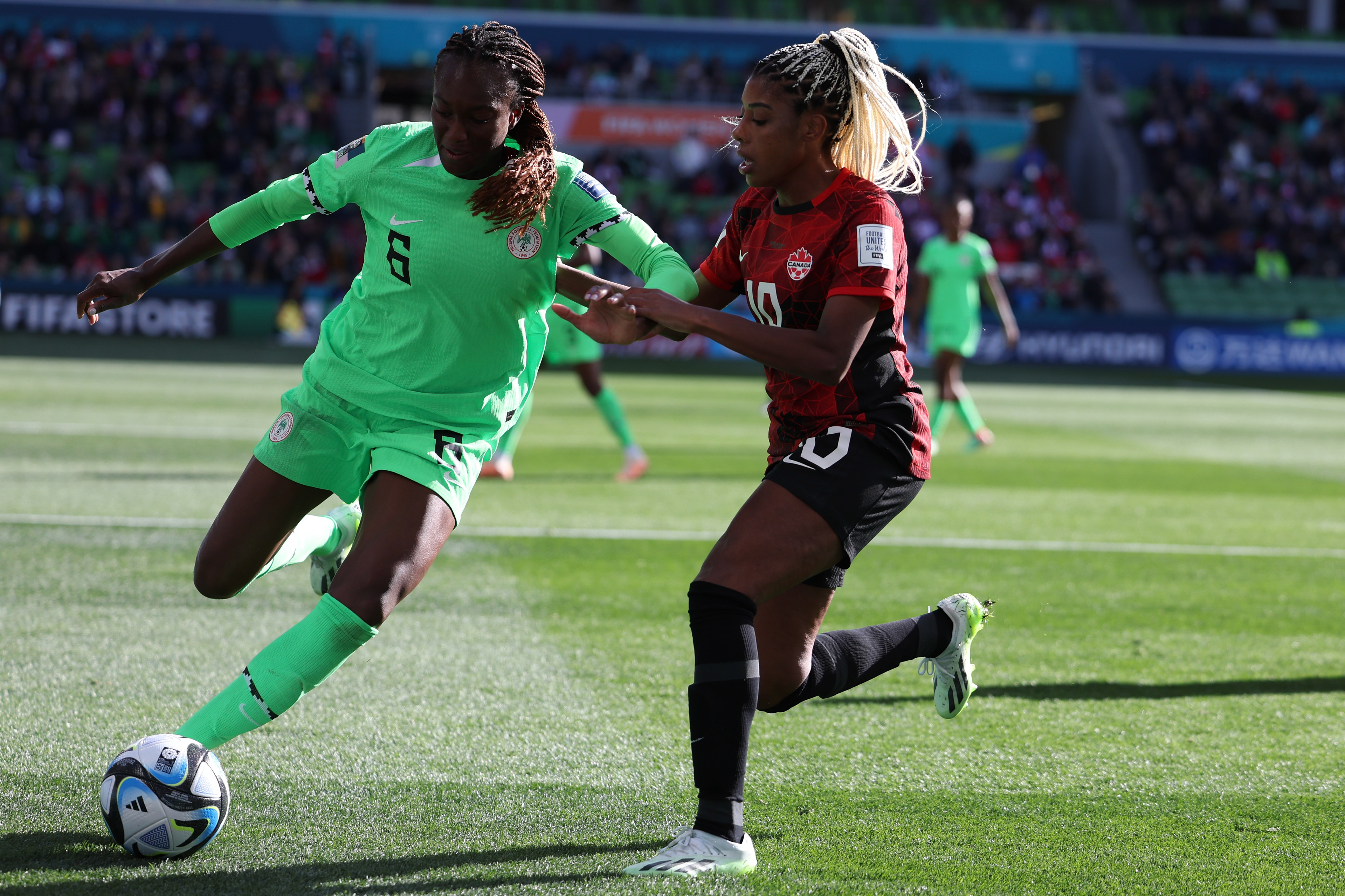 Nigeria's Ifeoma Onumonu, left, competes for the ball with Canada's Ashley Lawrence during the Women's World Cup Group B soccer match between Nigeria and Canada in Melbourne, Australia, Friday, July 21, 2023. (AP Photo/Victoria Adkins)