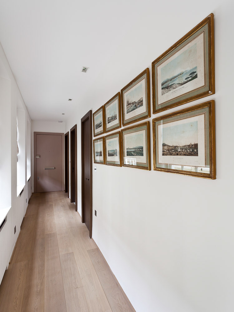The prints in this corridor were a key design decision: while the window reflections in the frames' glass is natural, they obscured the images: