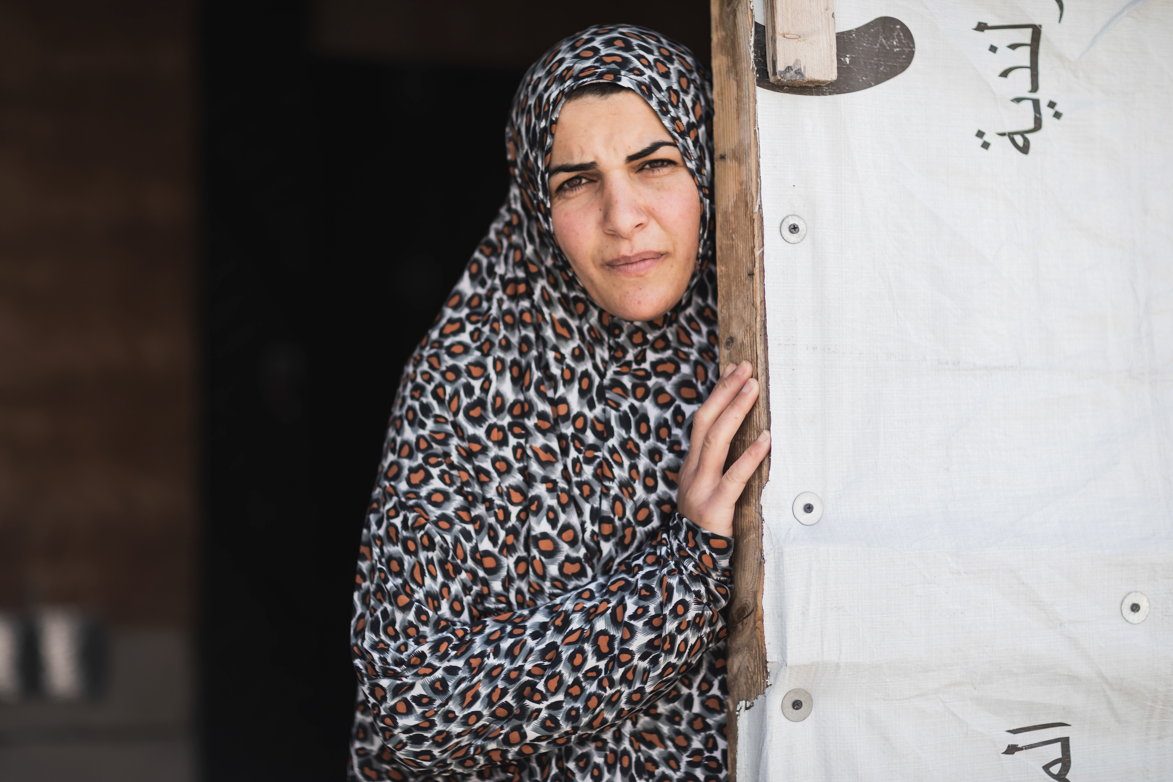 Douaa, Syrian refugee, at the entrance of her tent in Bekaa.