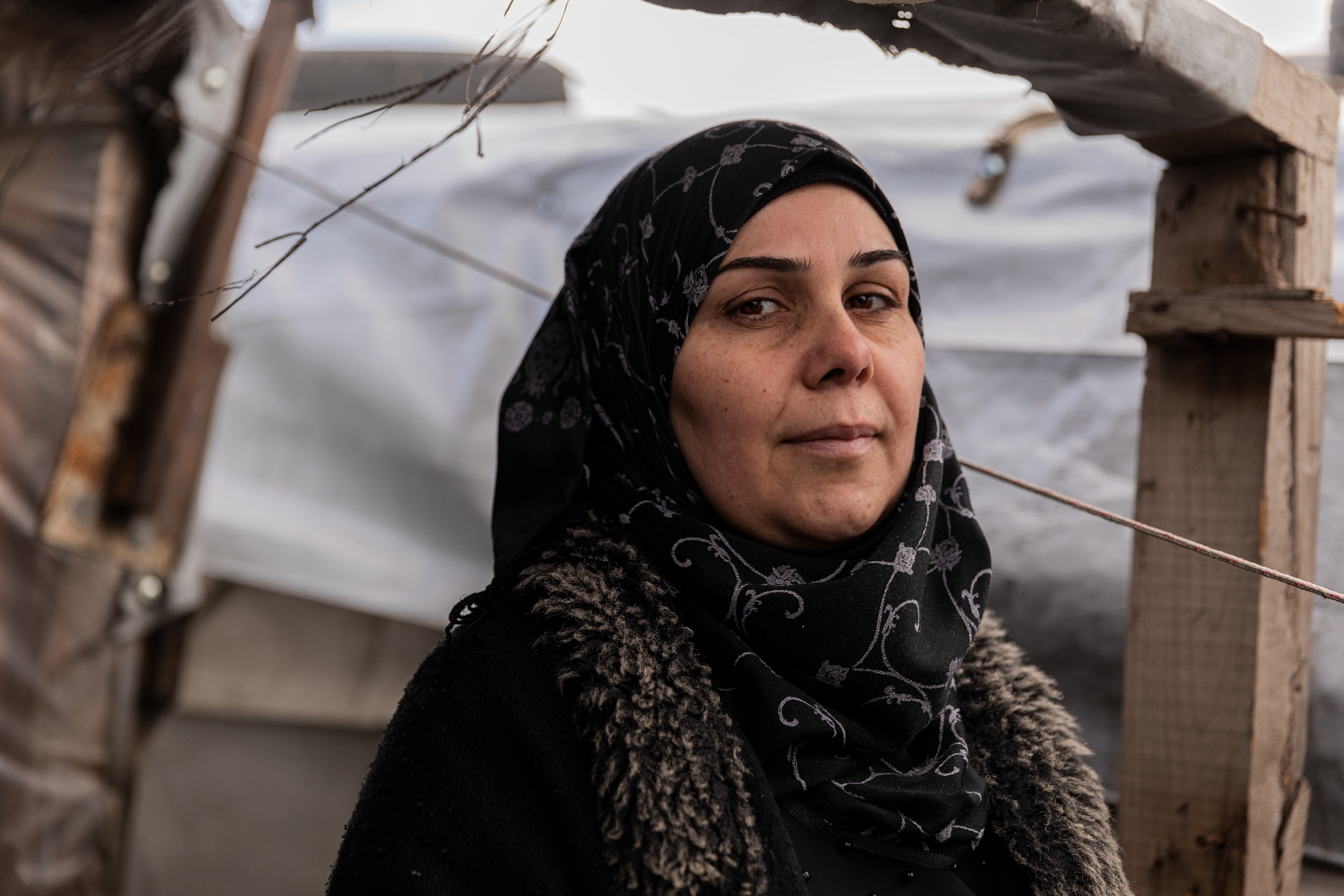 Hadil, Syrian refugee, inside her destroyed tent in Bekaa.