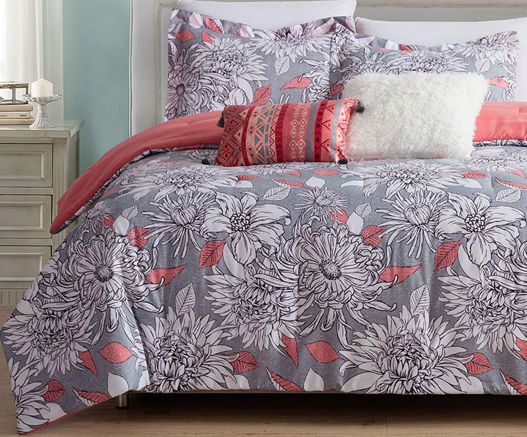 Bedding duvet and pillow set in oversized white, coral and grey floral pattern with accent pillows in aztec / geometric style