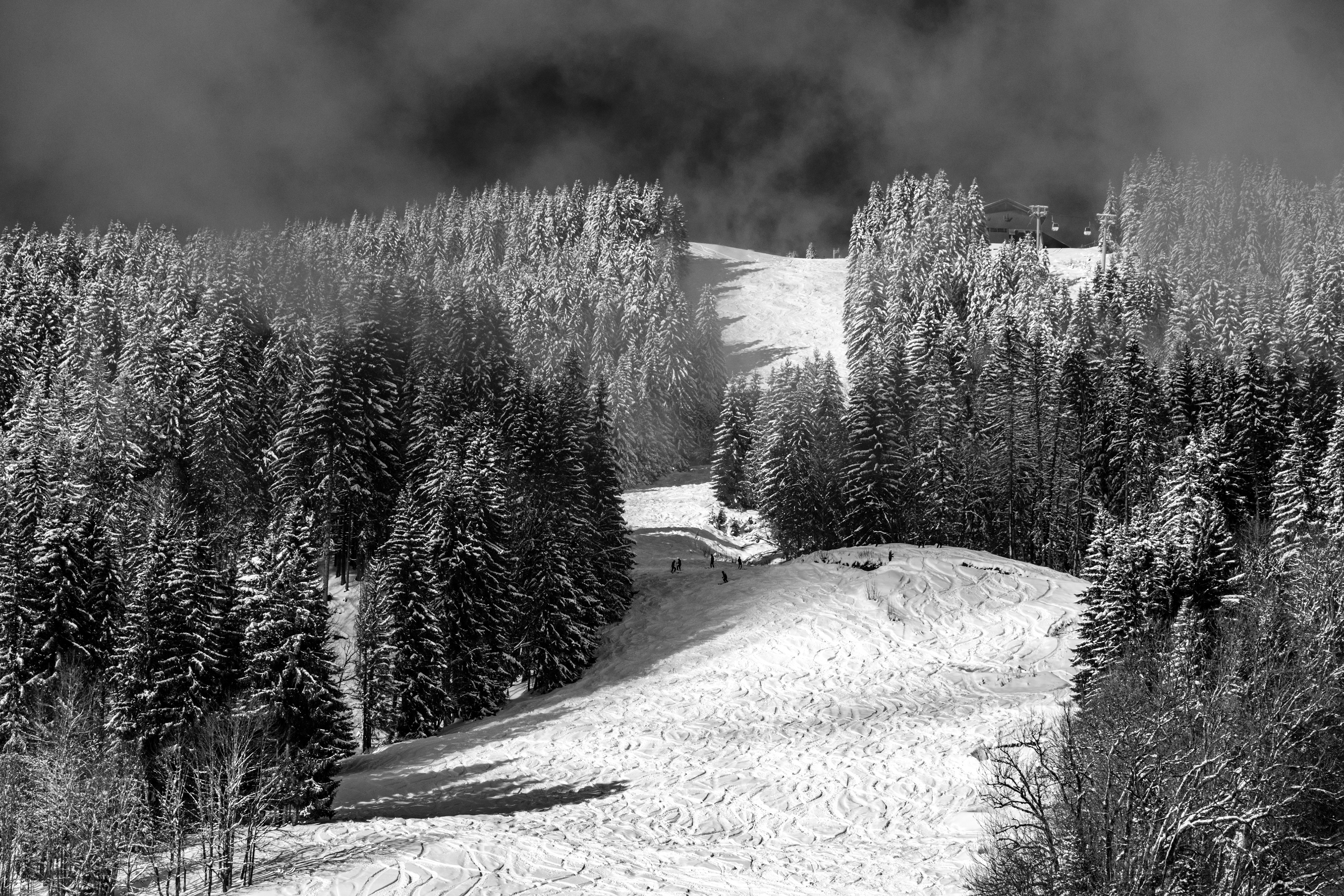 snowy ski run les gets sunset trees