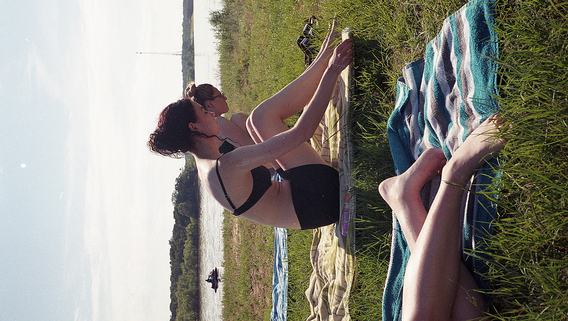 shelby, ava and elle tan on the banks of one of east texas' many lakes, the summer after graduating high school. 2021.