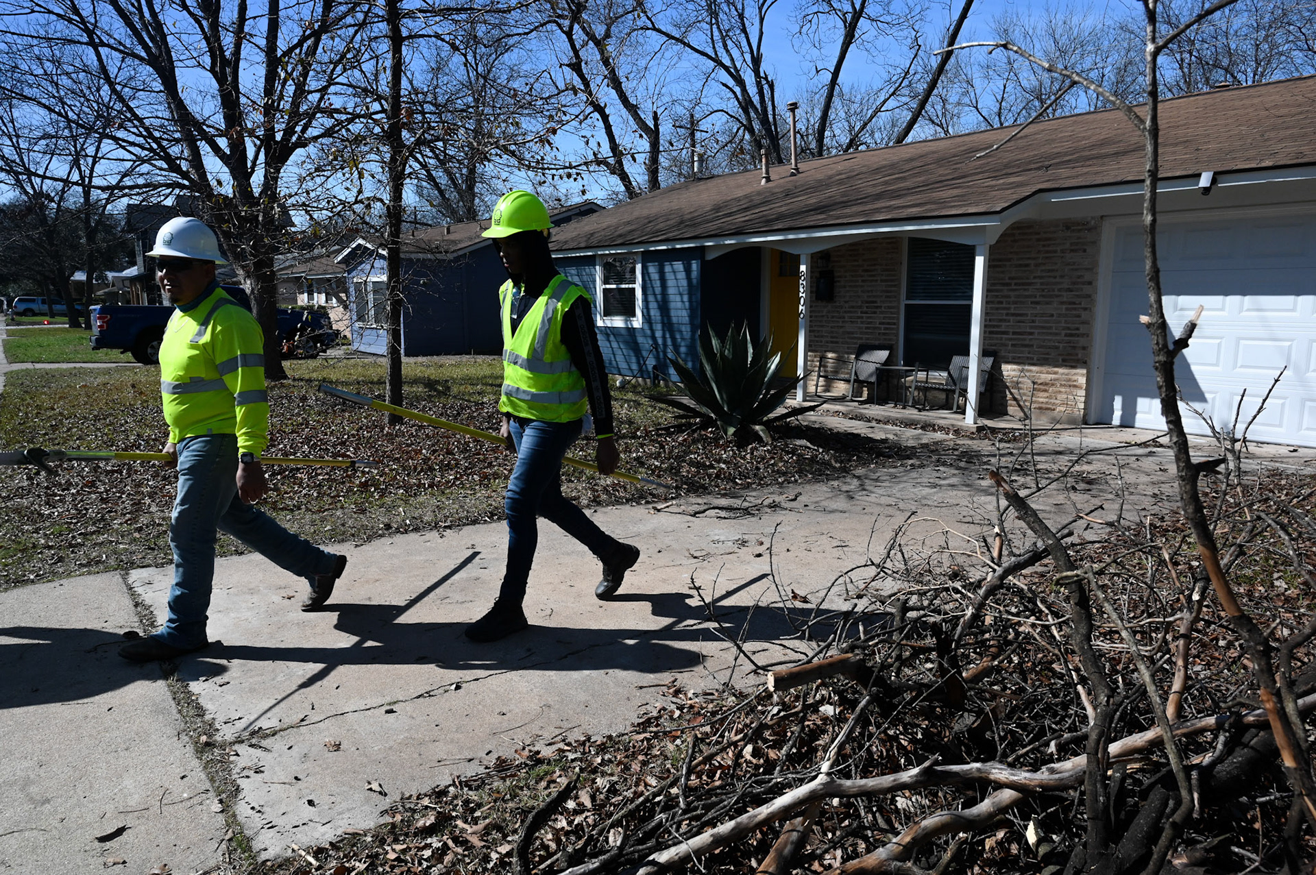 Wright tree service employees clear branches in North Shoal Creek on Feb. 4, 2023.