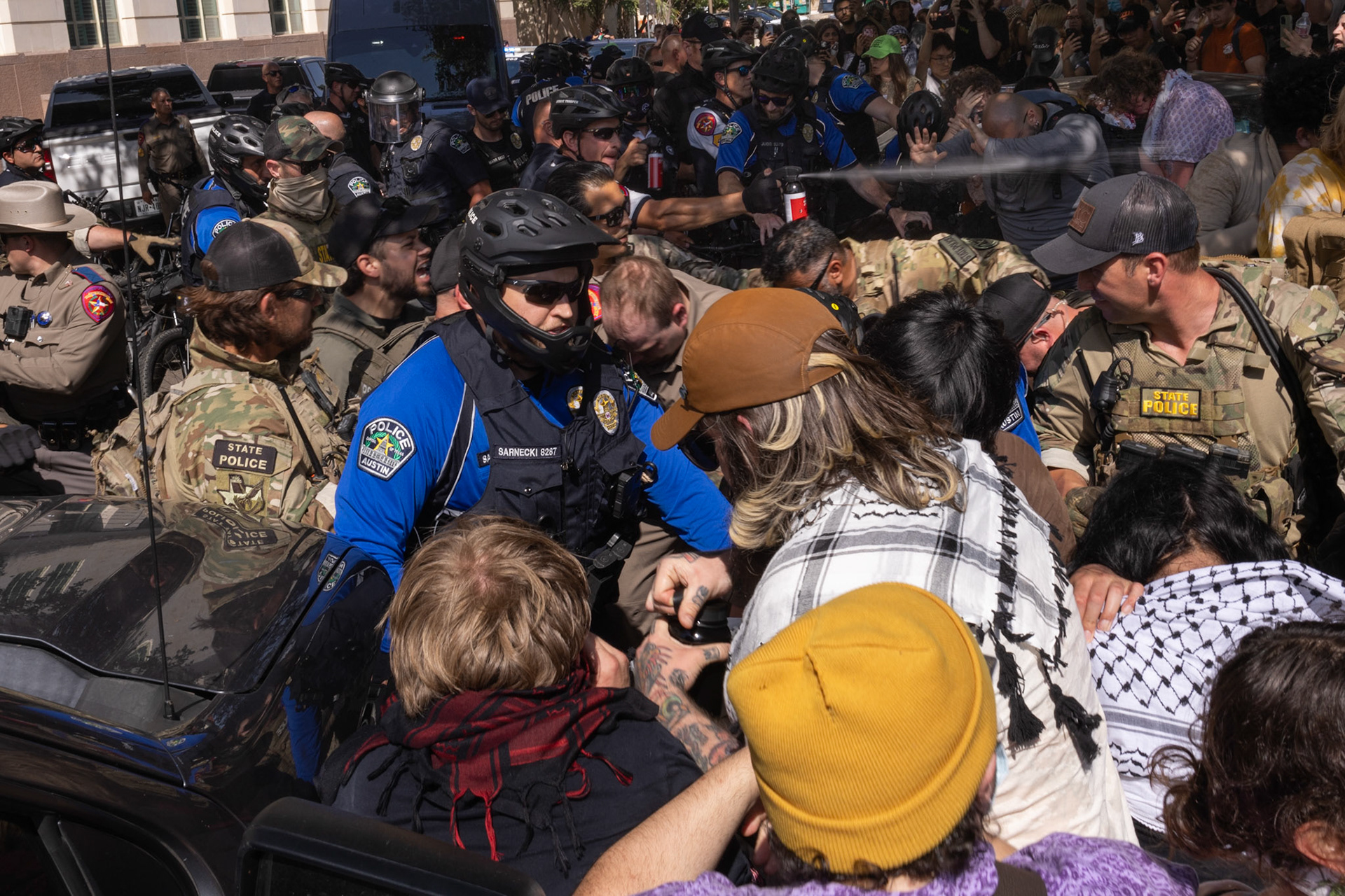 Law enforcement use pepper spray after ordering protestors to move off 22nd street to transport arrestees on Apr. 29, 2024.