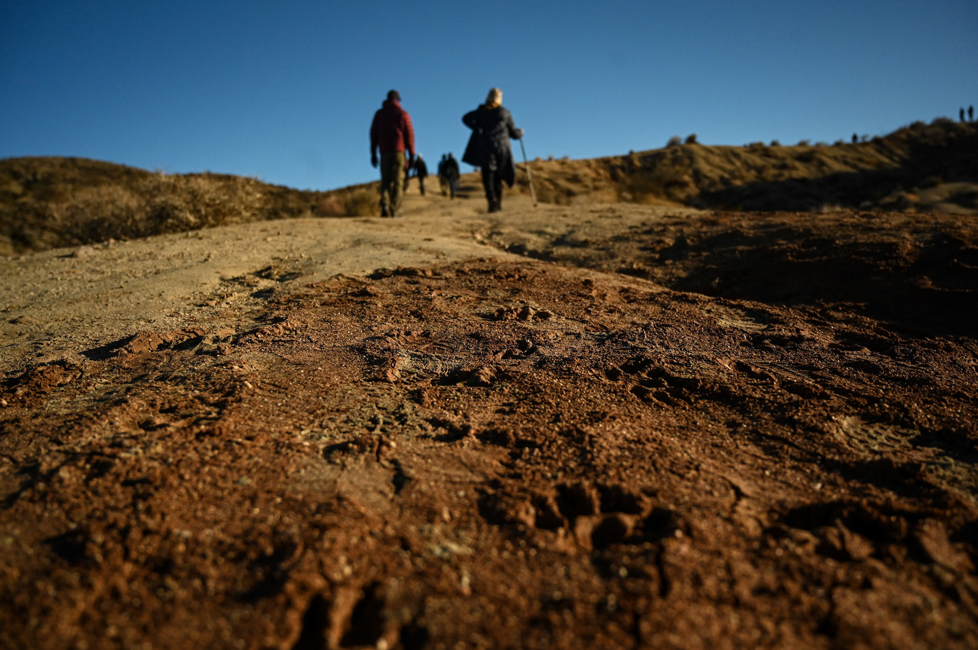 The long hike begins. Brother and sister trail behind children and nephews.